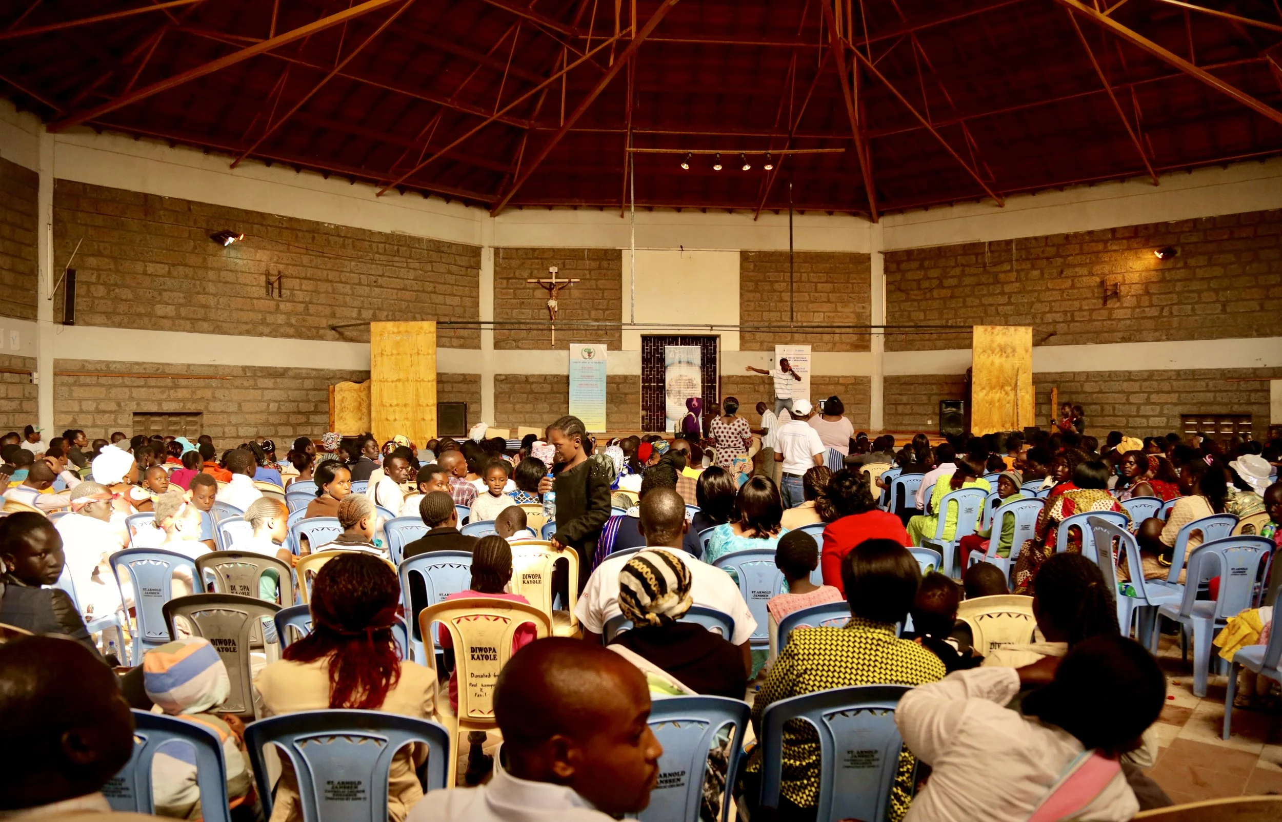 Refugees, community members and church leaders attend World Refugee Day celebrations at Divine Word Church in Nairobi's Kayole estate.
