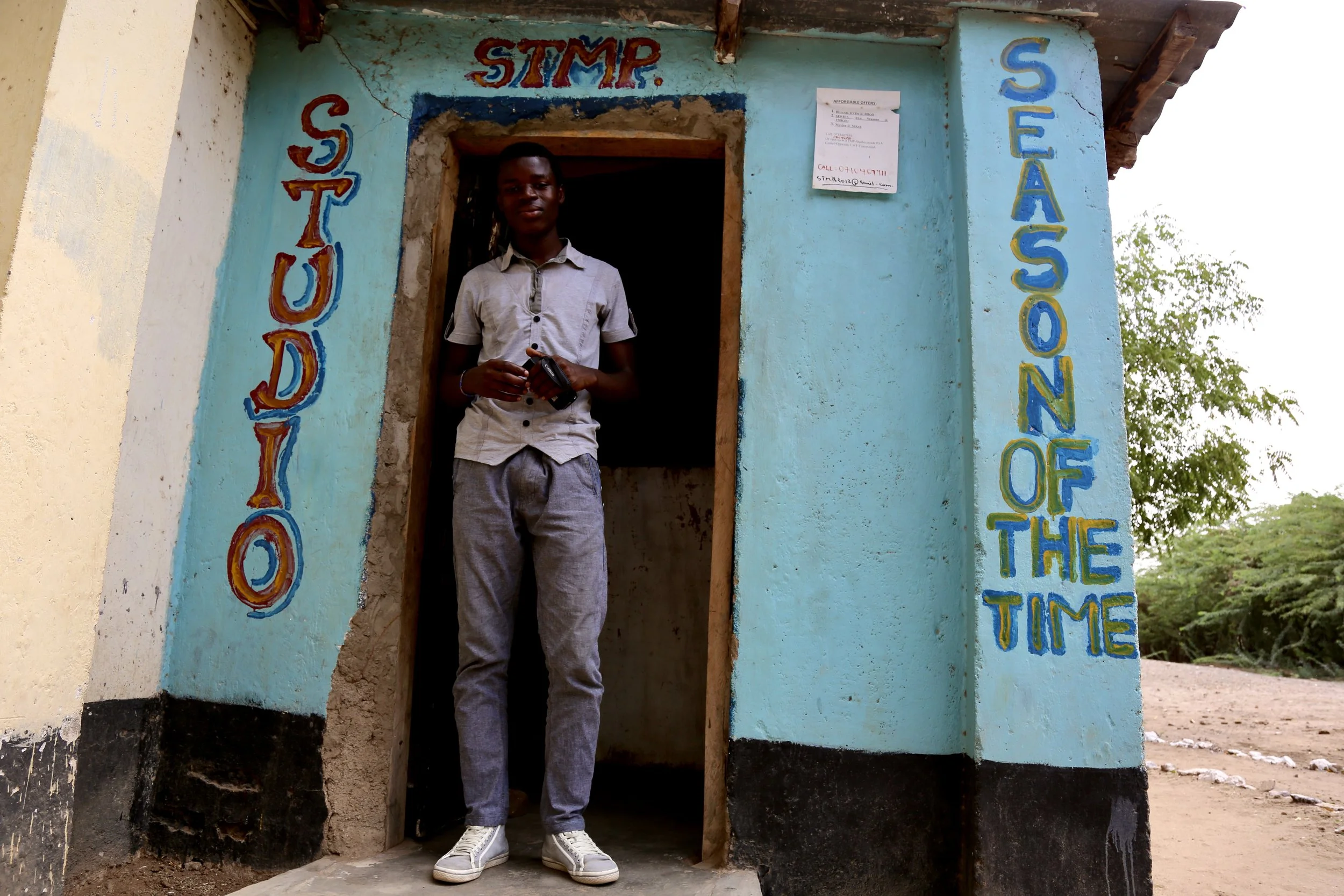 Fidele Wabenga stands at the entrance of his studio in Kakuma Refugee Camp, where he created a space for storytelling and opportunity.