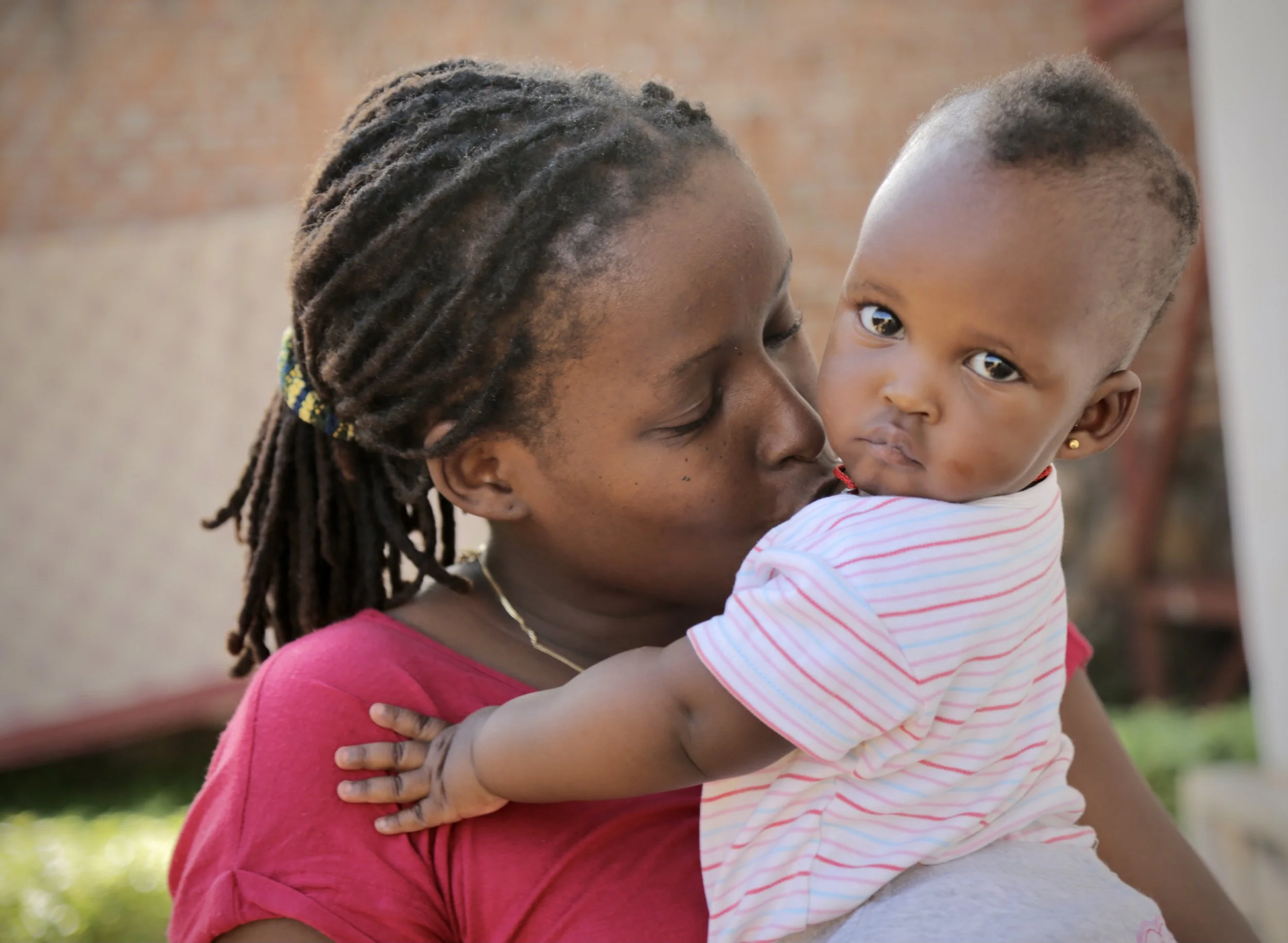 Pamela Kazekare holds her daughter Shikiro inside the Kigali compound where Burundian refugees lived together in exile after fleeing Burundi’s 2015 political crisis. Having grown up during Burundi’s 1993–2003 civil war, Kazekare fled to Rwanda with S