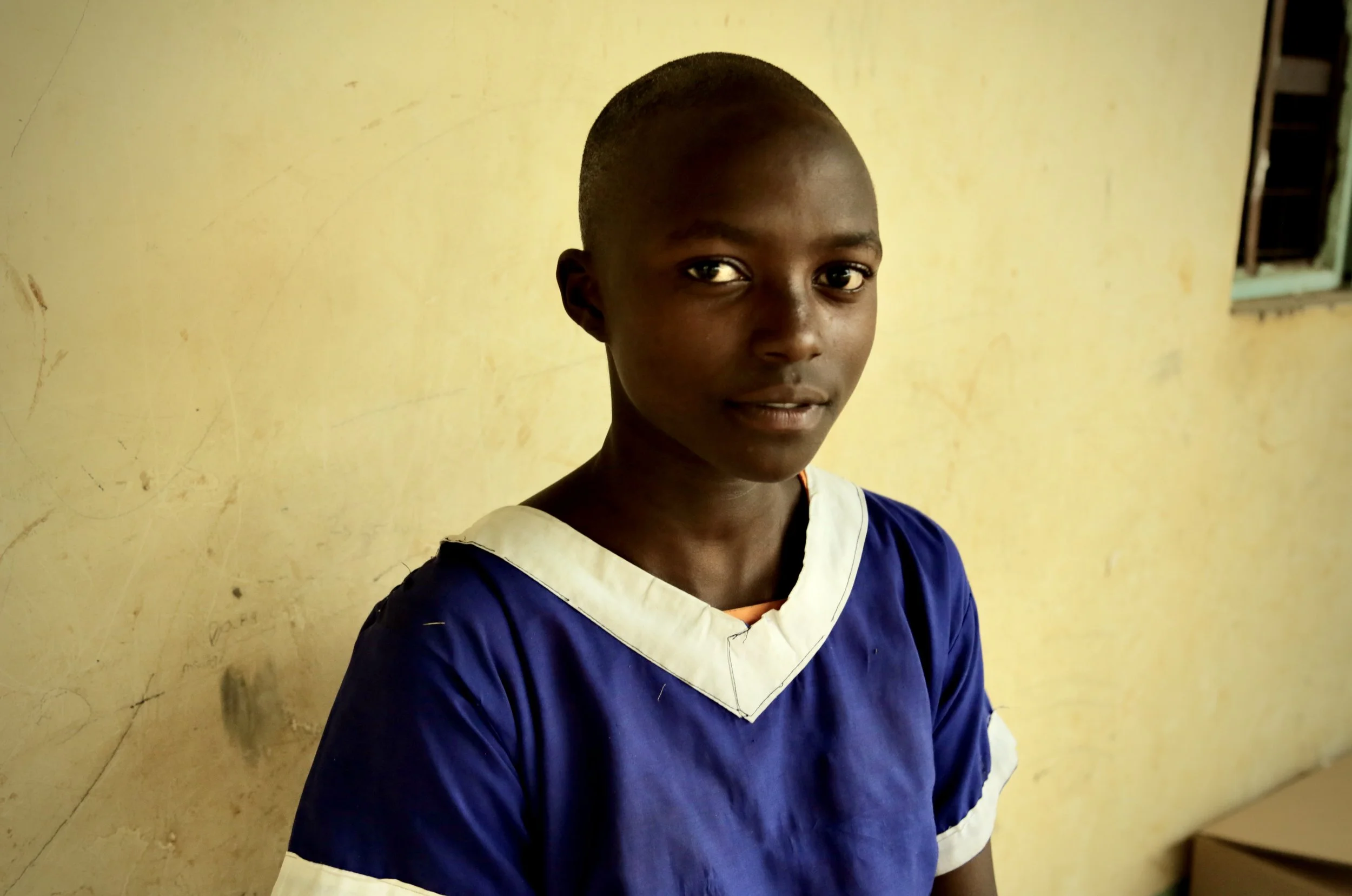 Trezer Ndunde, a pupil at Albertos Divine Providence School, poses for a portrait in Kakamega County, Kenya. Trezer says she spends part of every evening collecting water, carrying a 20-litre container on her head and making three trips. "I would be 