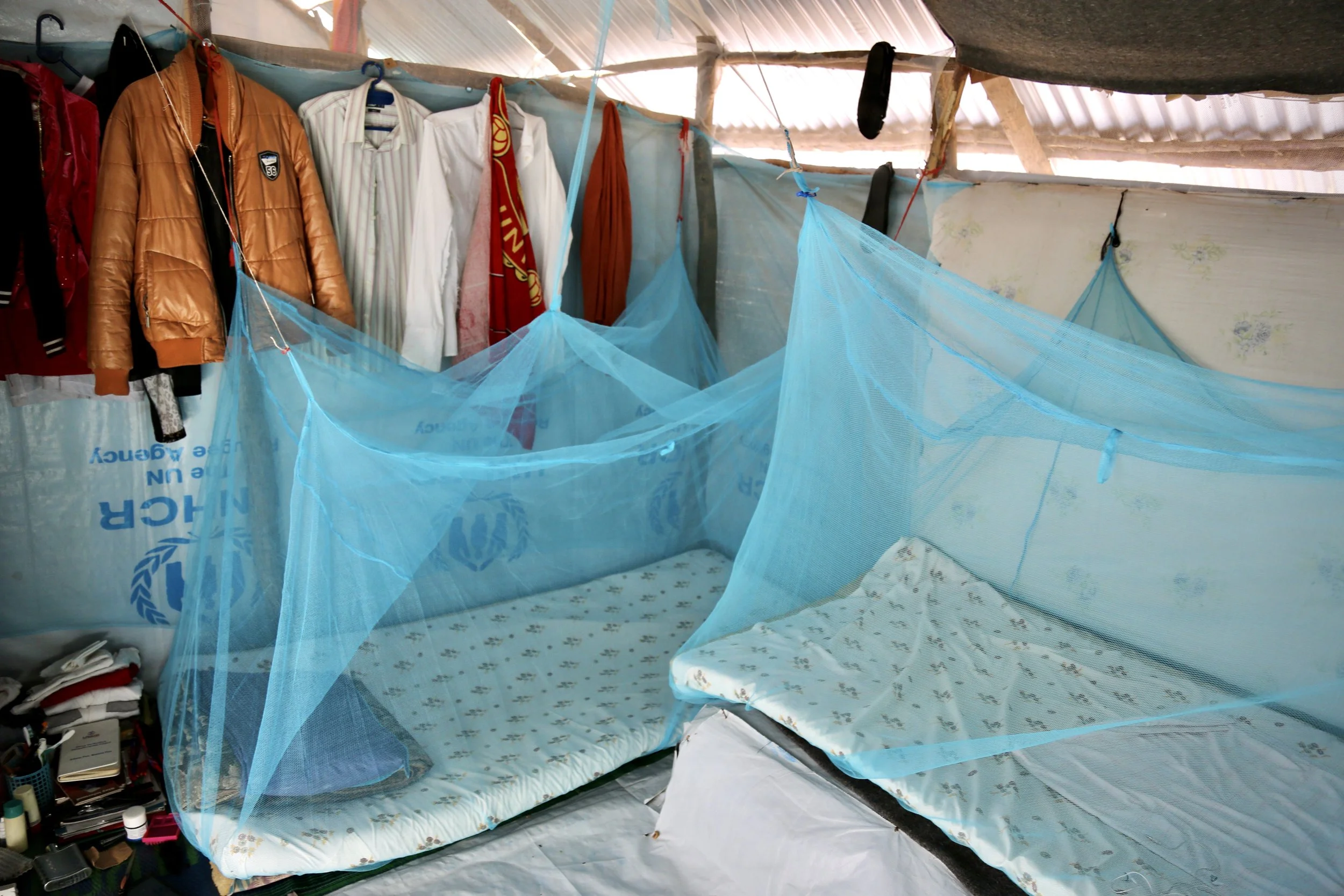 Mosquito nets hang above beds inside a shared shelter in Kakuma refugee camp. Several LGBTQ+ refugees described overcrowded living conditions and limited privacy.