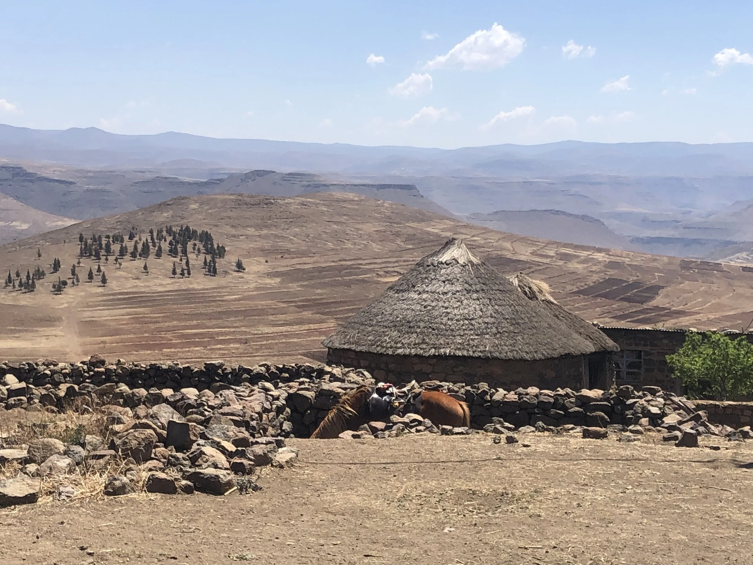 Palesa's rondavel overlooking the valleys of Thaba Moorosi, Lithipeng. The mountainous terrain contributes to the isolation experienced by many families living in Lesotho’s highlands.