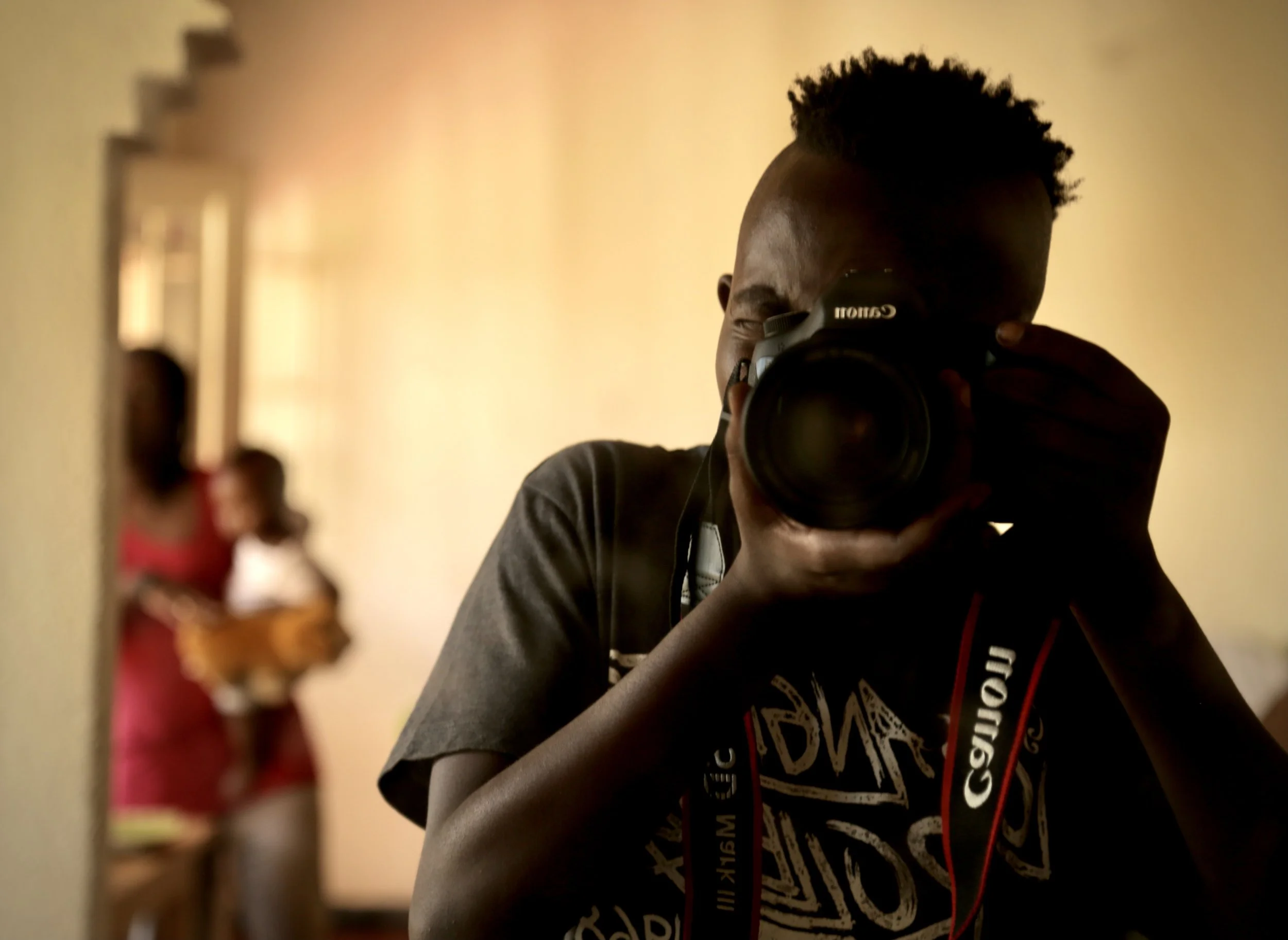 Venuste Maronko, a young Burundian filmmaker and artist who fled Bujumbura during Burundi’s 2015 political crisis, photographs life inside the Kigali compound using Elsa Buchanan’s second camera. Before fleeing into exile, Maronko had been studying c