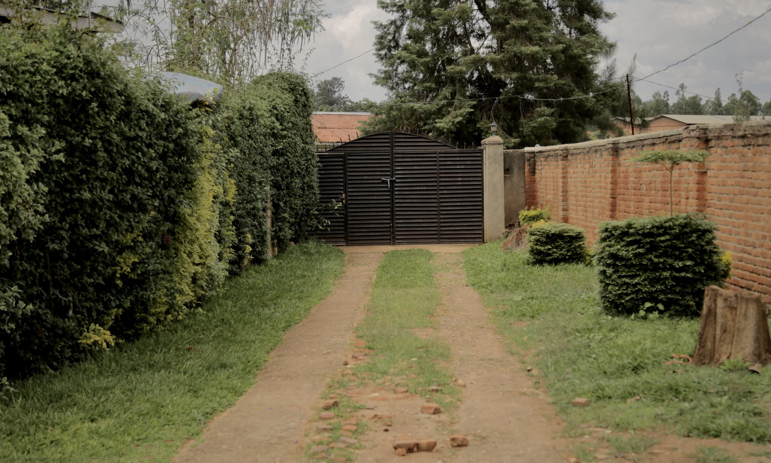 The gated entrance to the house in Kigali, Rwanda, shared by 14 Burundian refugees, activists and former protesters who fled political violence following Burundi’s 2015 crisis. Because Burundian security services and informants were believed to opera