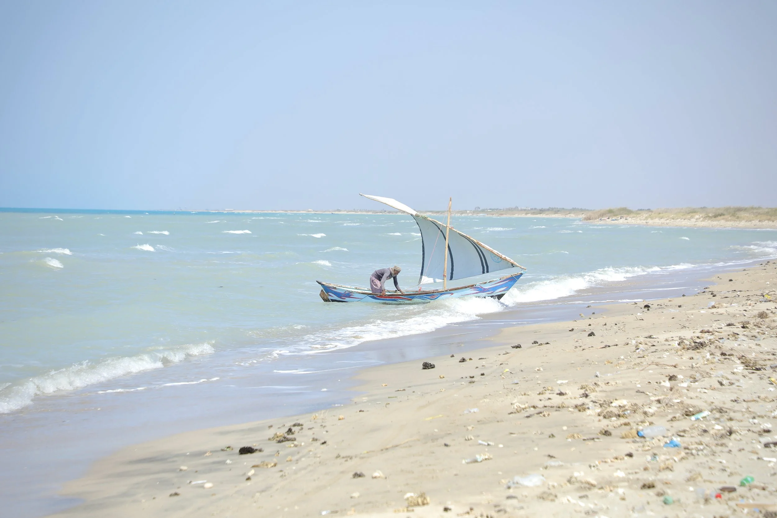 Small wooden fishing boats line the coast near Al Khokha. Many fishermen continue using traditional vessels with no equipment capable of detecting naval mines or water-borne explosive devices. Yemen.