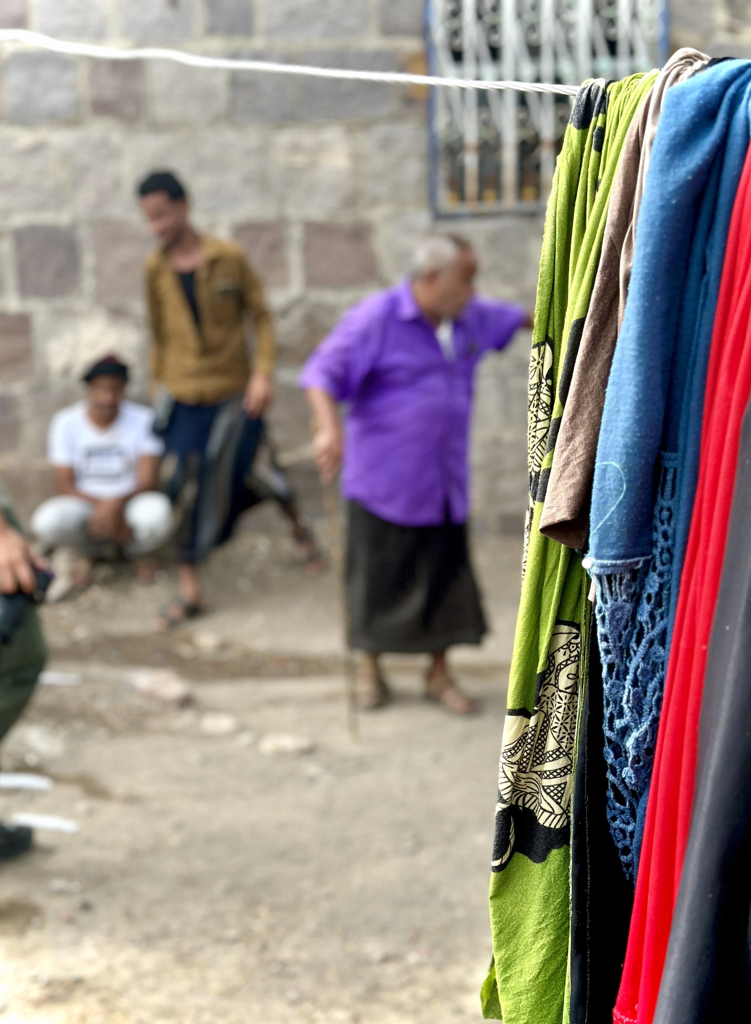 The courtyard of Mosaid Mohammed Ali Naji's home, Shakhab, Al Dhale. Mosaid - in the purple shirt he wears throughout these photographs - moves through the compound with members of his family. Further landmines were discovered along his property wall