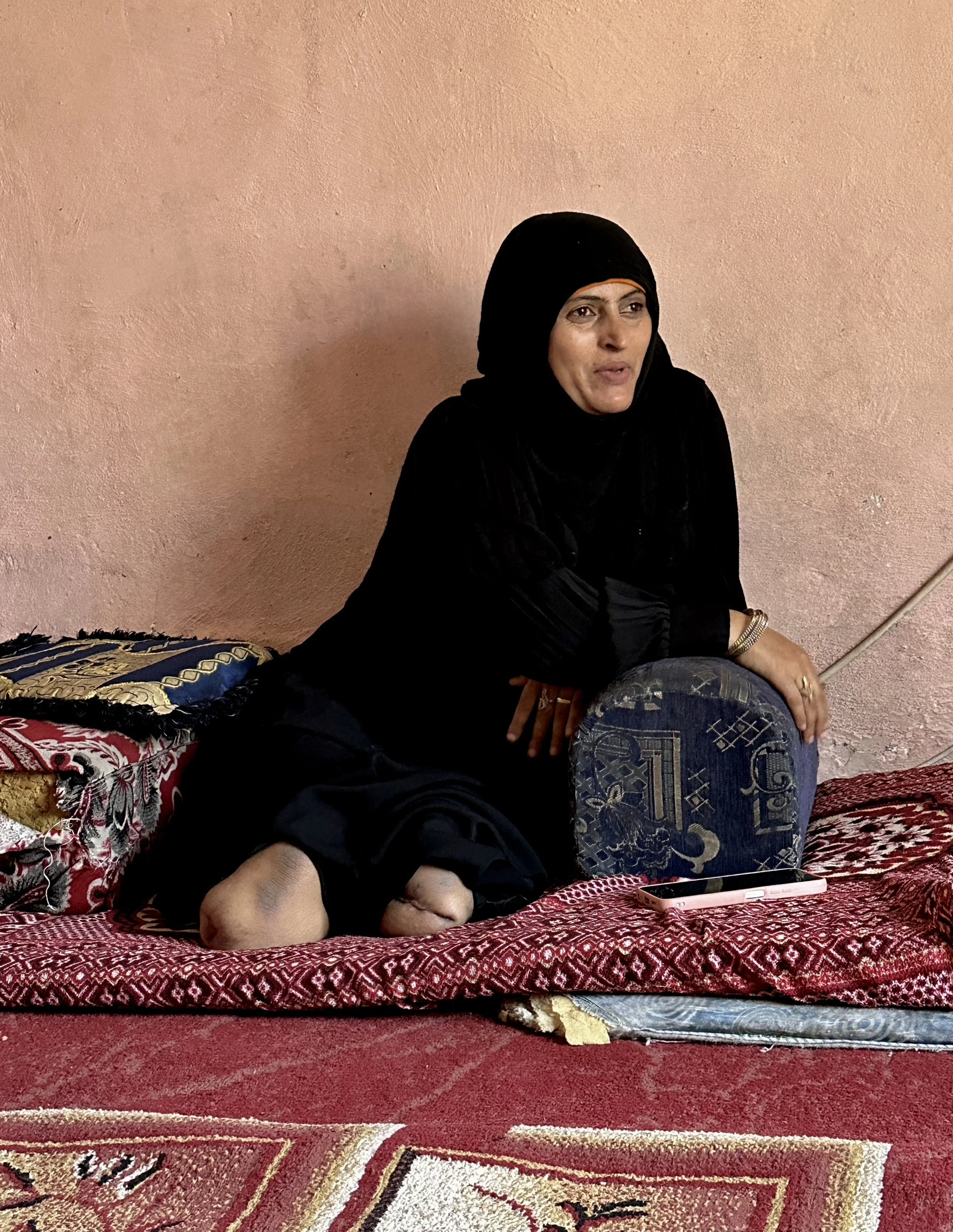 Qoboul Ahmed Al-Hajj, 70, stands beside her daughter Dalila Abdo Ahmed inside their apartment in Taiz. Qoboul travelled from the Al-Shakhab area of Saber Al-Mawadim District to support her daughter and refused to abandon her despite the stigma often 