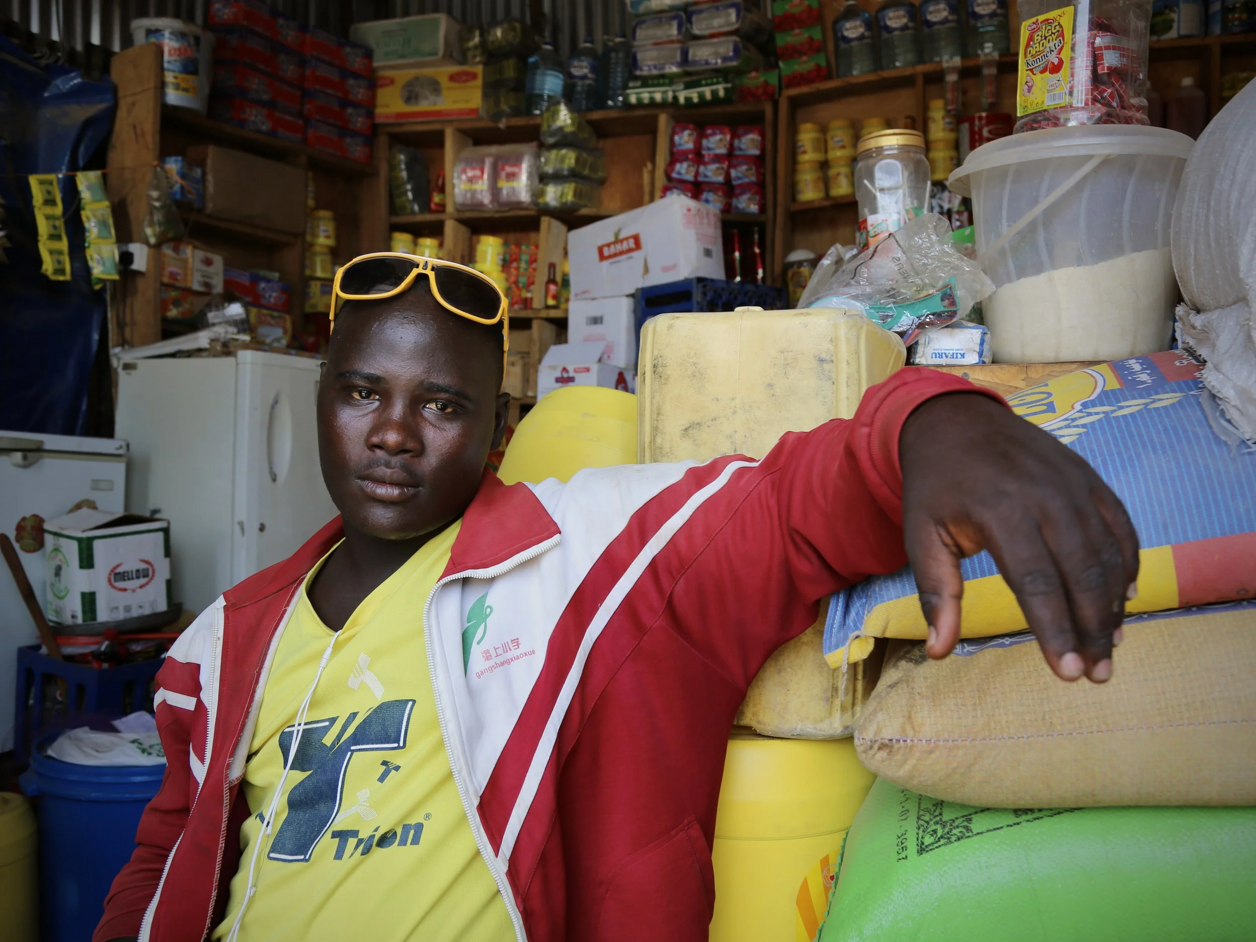 A young man poses inside a small shop in Kakuma refugee camp, Kenya.