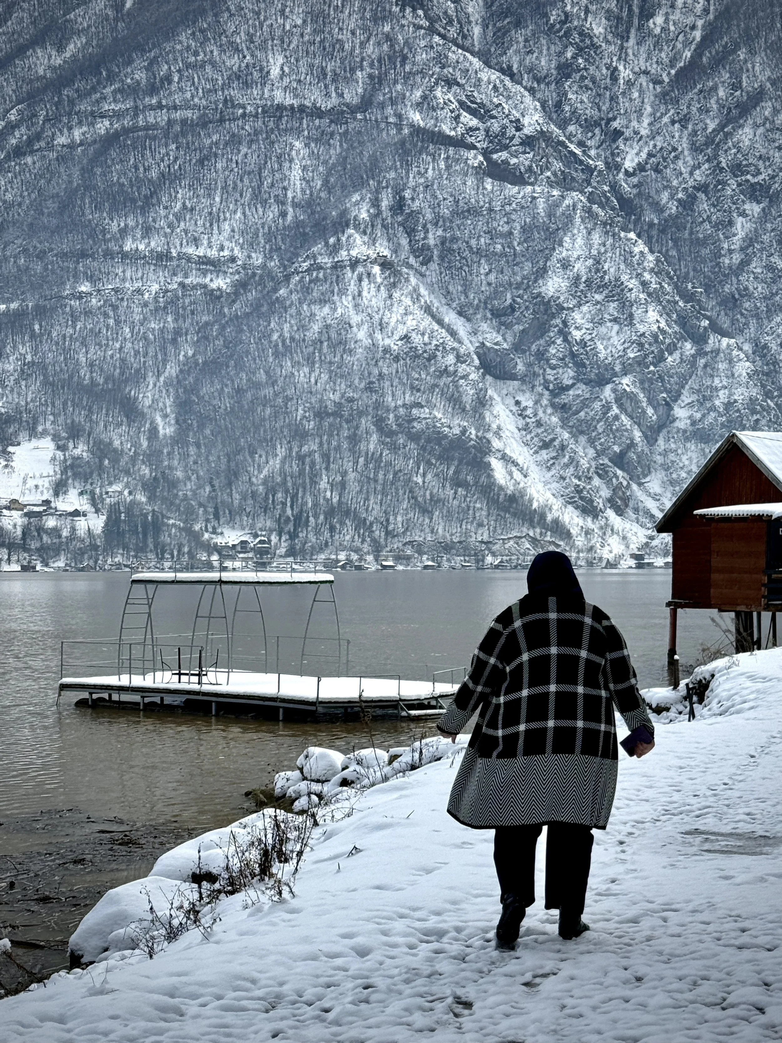 Begija Vejzović Smajić, a mathematics teacher in Srebrenica town, stands near the lake. She was twelve years old when her father was killed during the genocide. Today she speaks publicly as a survivor and works to ensure younger generations understan