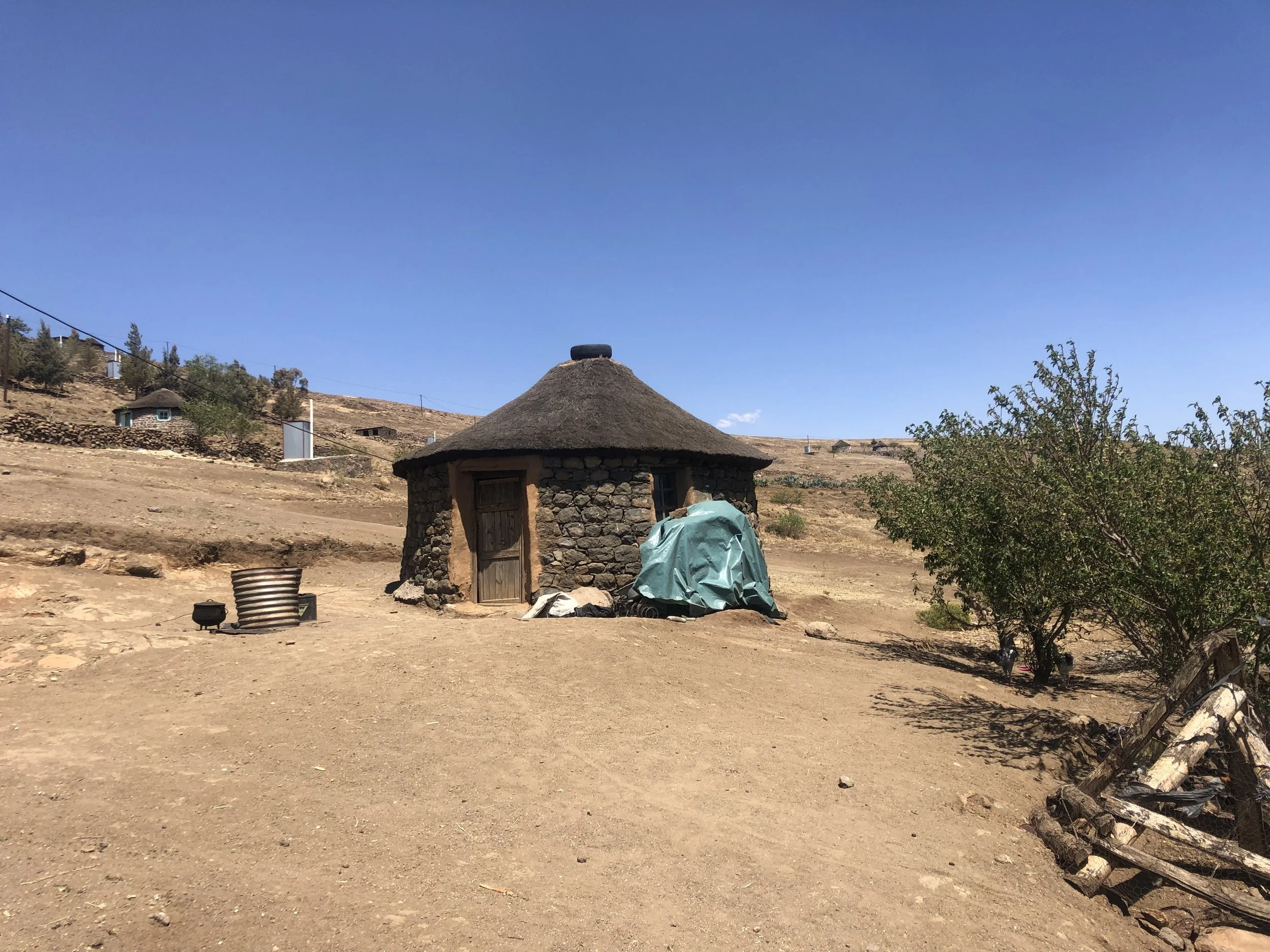 A small stone rondavel in Thaba Moorosi where Bokang Khera and an elderly caregiver lived together in isolation. Though physically small for his age because of malnutrition, Bokang was 16 years old and had only attended school up to Class 7.