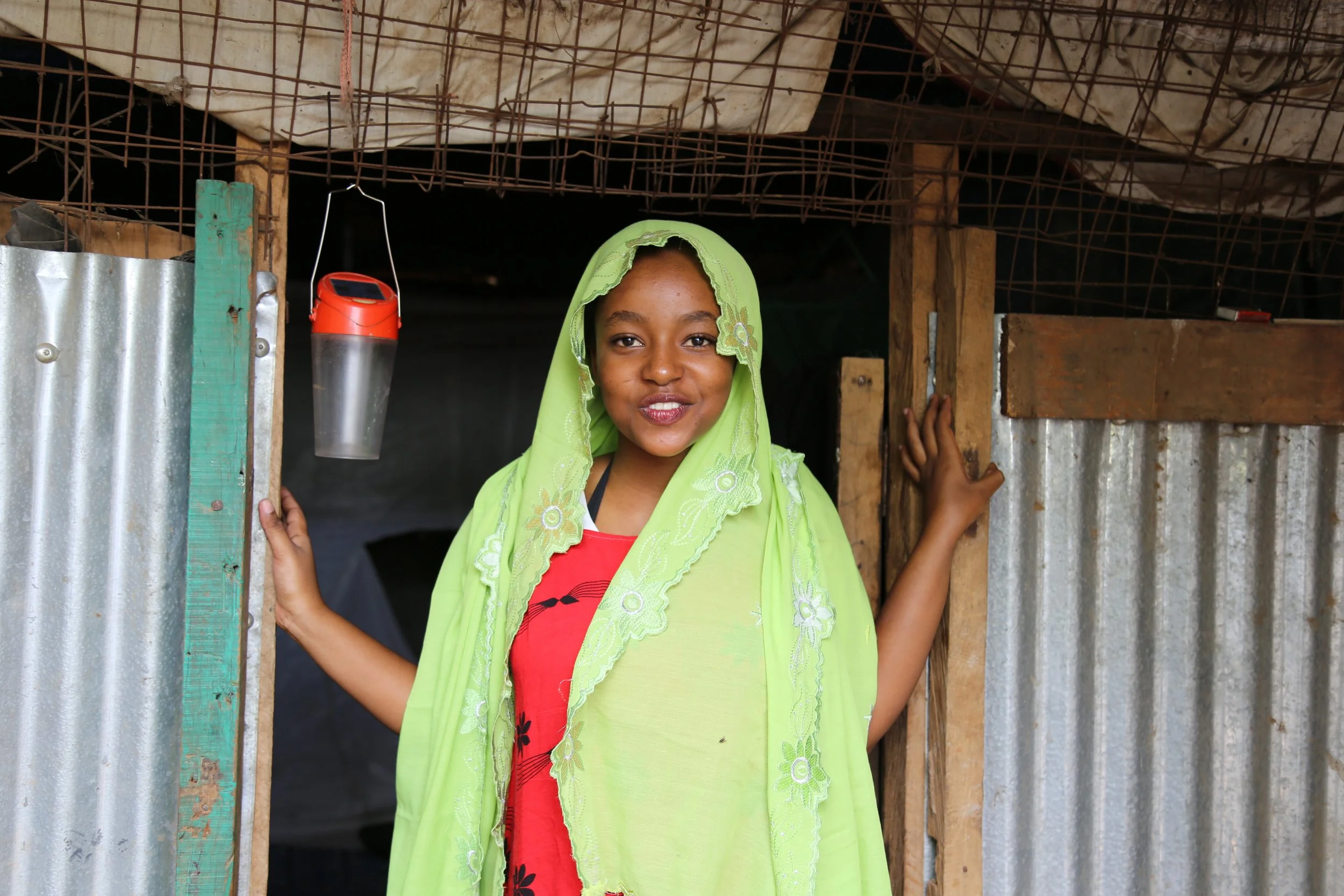 Shemsa at home

Shemsa, the daughter of Mariam Nininahazwe, stands at the entrance of the family home in Kakuma refugee camp. Mariam supports Shemsa and her siblings through the work she carries out from their shelter.