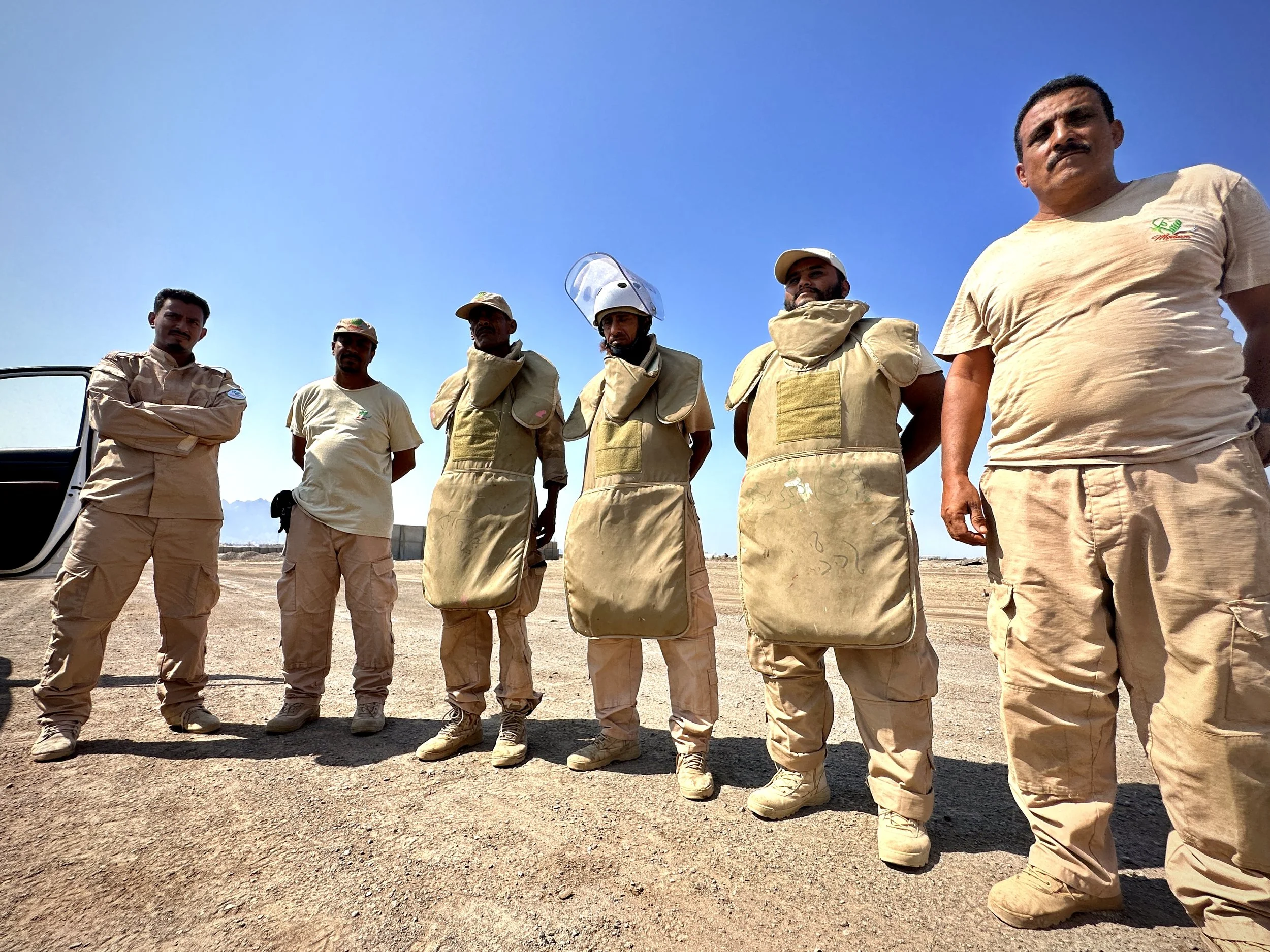 Members of Project Masam Team 24 stand together during operations at Aden International Airport. The team continues unexploded ordnance and mine-clearance work aimed at improving safety and supporting the airport’s long-term recovery.