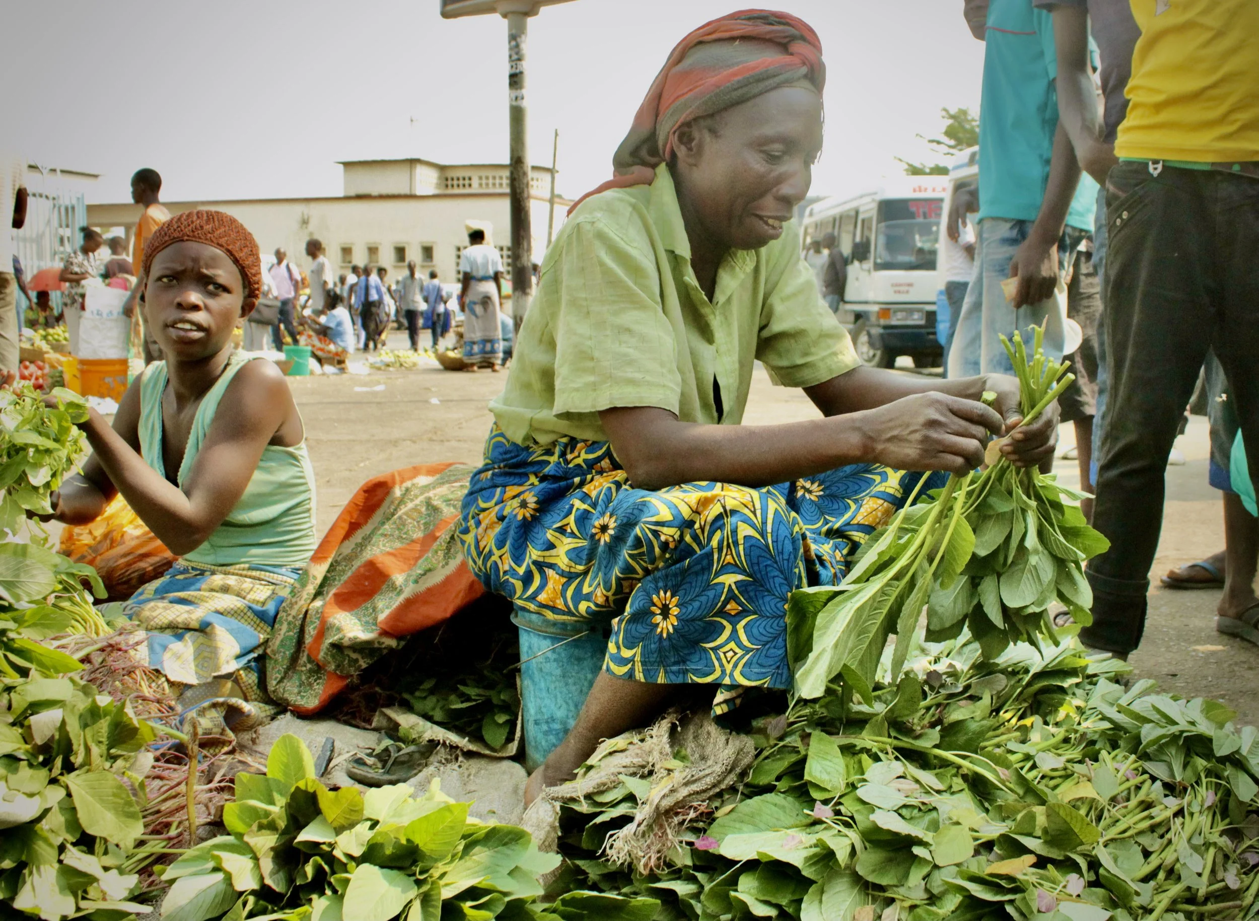 Consa, 75, sorts lenga-lenga and amaranth leaves for sale at a market in Bujumbura. Like many traders, she reported struggling to find customers as the political crisis increasingly affected household spending.