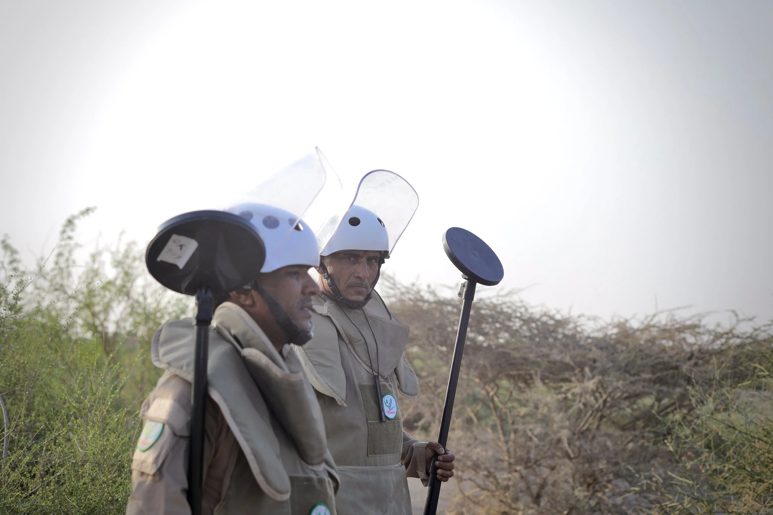 Deminers walk towards the start of designated safe lanes in Al Remah, near Mocha, Taiz governorate, Yemen. Clearance operations are often guided by reports from local residents and prior incidents in the area.