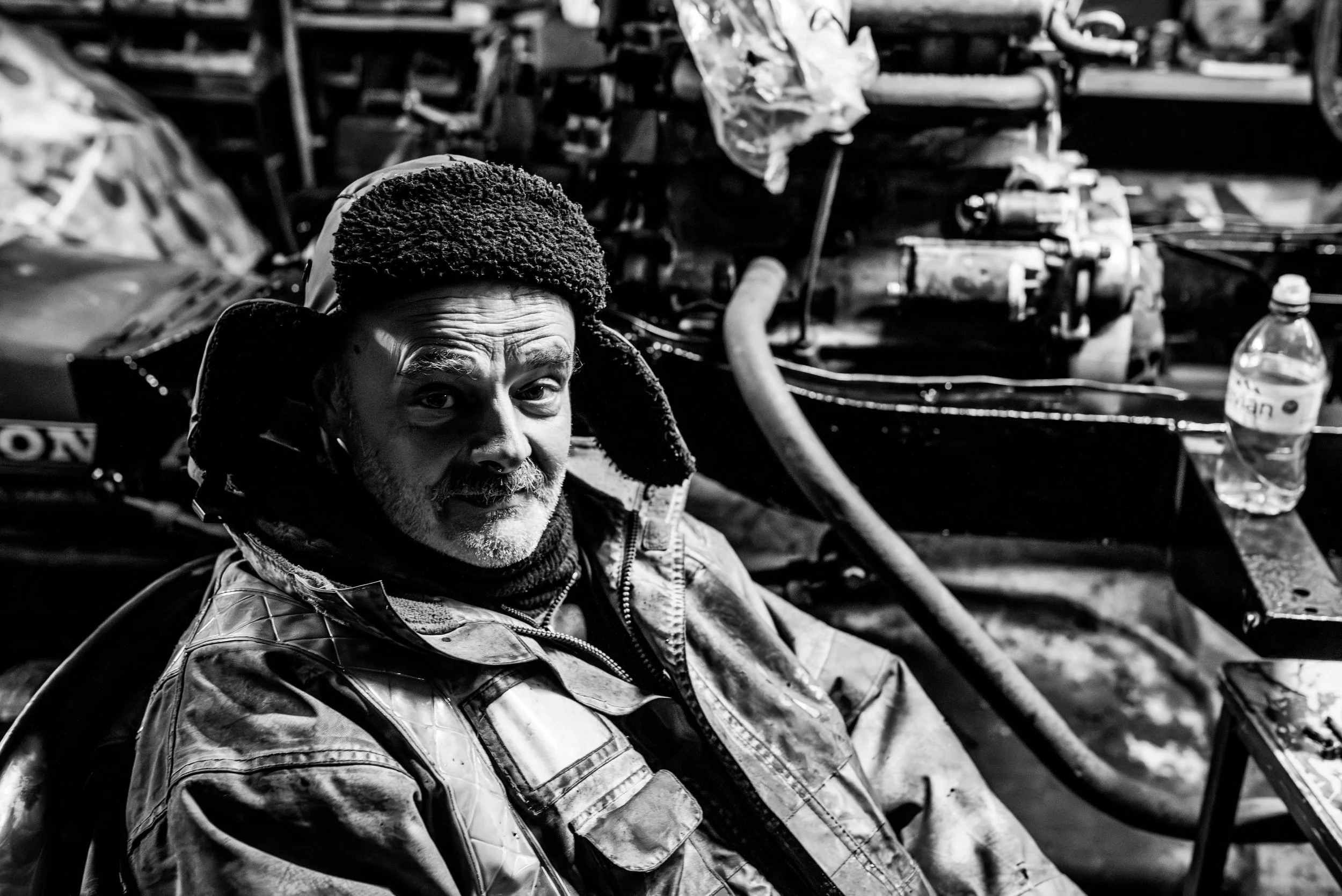 Kev the mechanic sits amongst his work