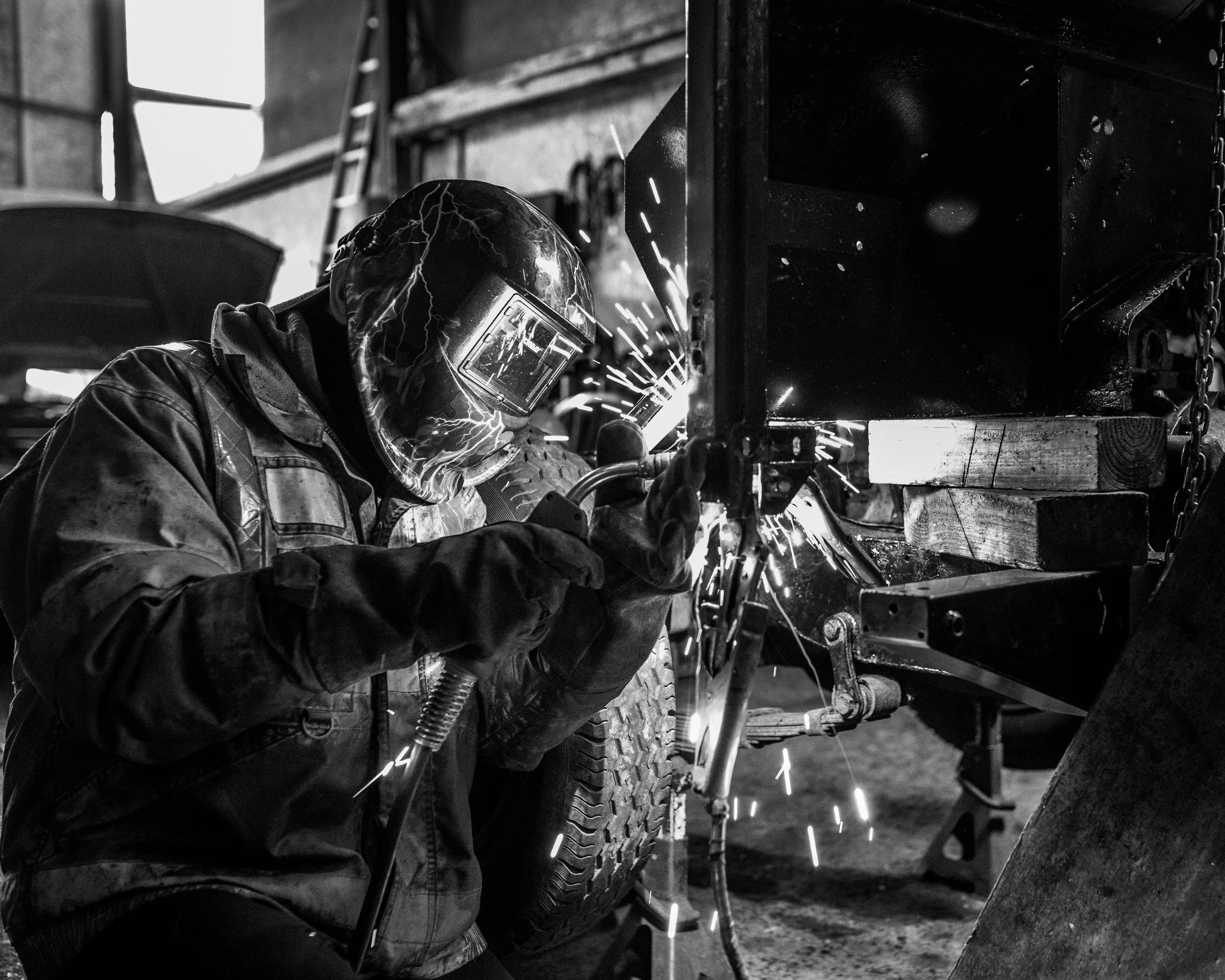 Welder in mask with sparks