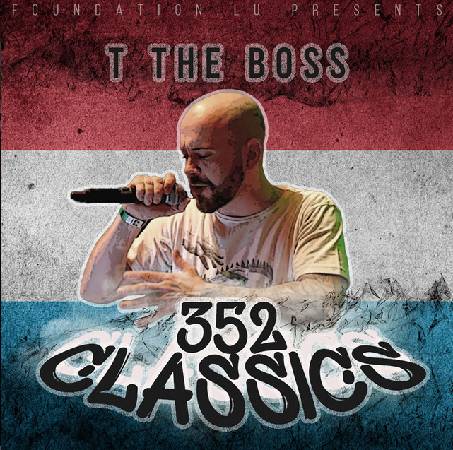 A man with a shaved head and beard holding a microphone, with a tattoo on his arm, standing in front of a background with red, white, and blue stripes and stylized mountain graphics, looking down with his eyes closed.