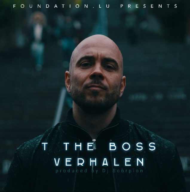 A man with a shaved head and beard standing outdoors in front of a dark staircase or steps, with a blurred person in the background. The image is dark and moody with text overlay including "Foundation.lu presents," "T The Boss Verhalen," and "produced by DJ Scorpion."