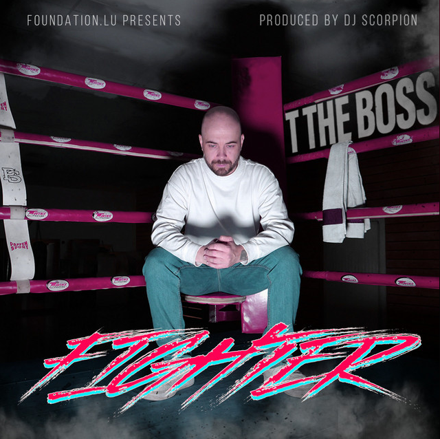A man sitting in a boxing ring with pink ropes, looking down with a serious expression, with a towel hanging on the ropes, and a sign in the background that says 'THE BOSS'; text at the top mentions 'Foundation.lu presents' and 'Produced by DJ Scorpion'; bold stylized text at the bottom says 'FIGHTER'.
