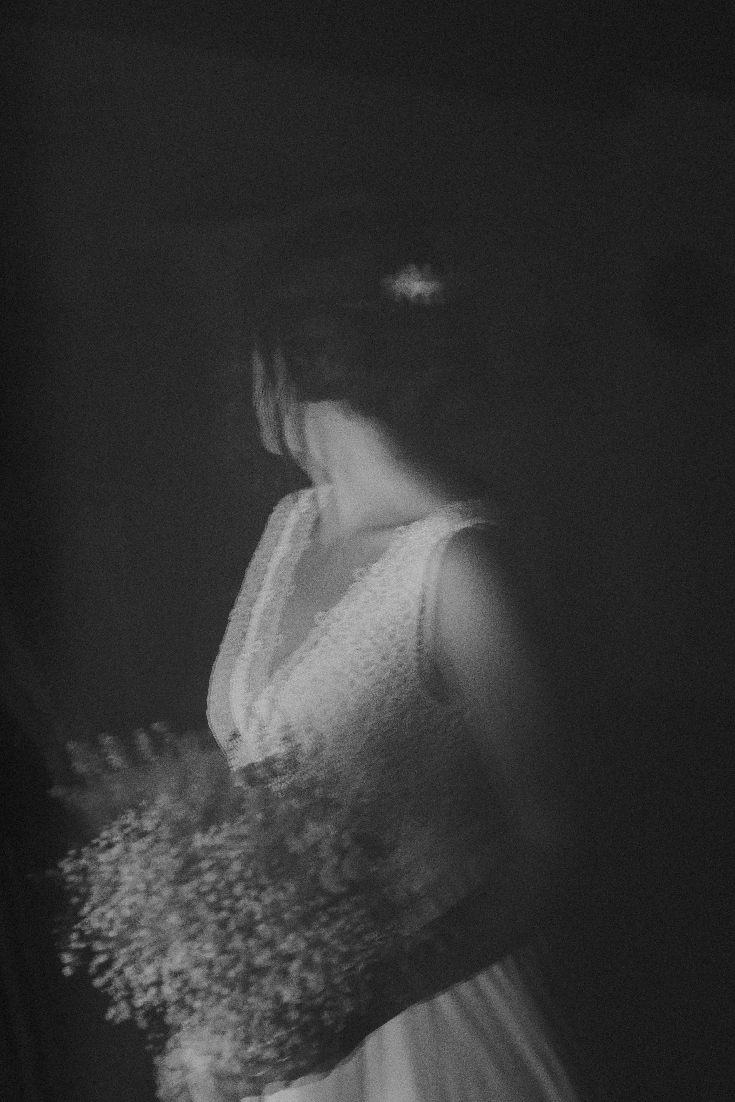 Ragazza vestita con abbigliamento elegante, fotografata in bianco e nero con un effetto di riflesso.