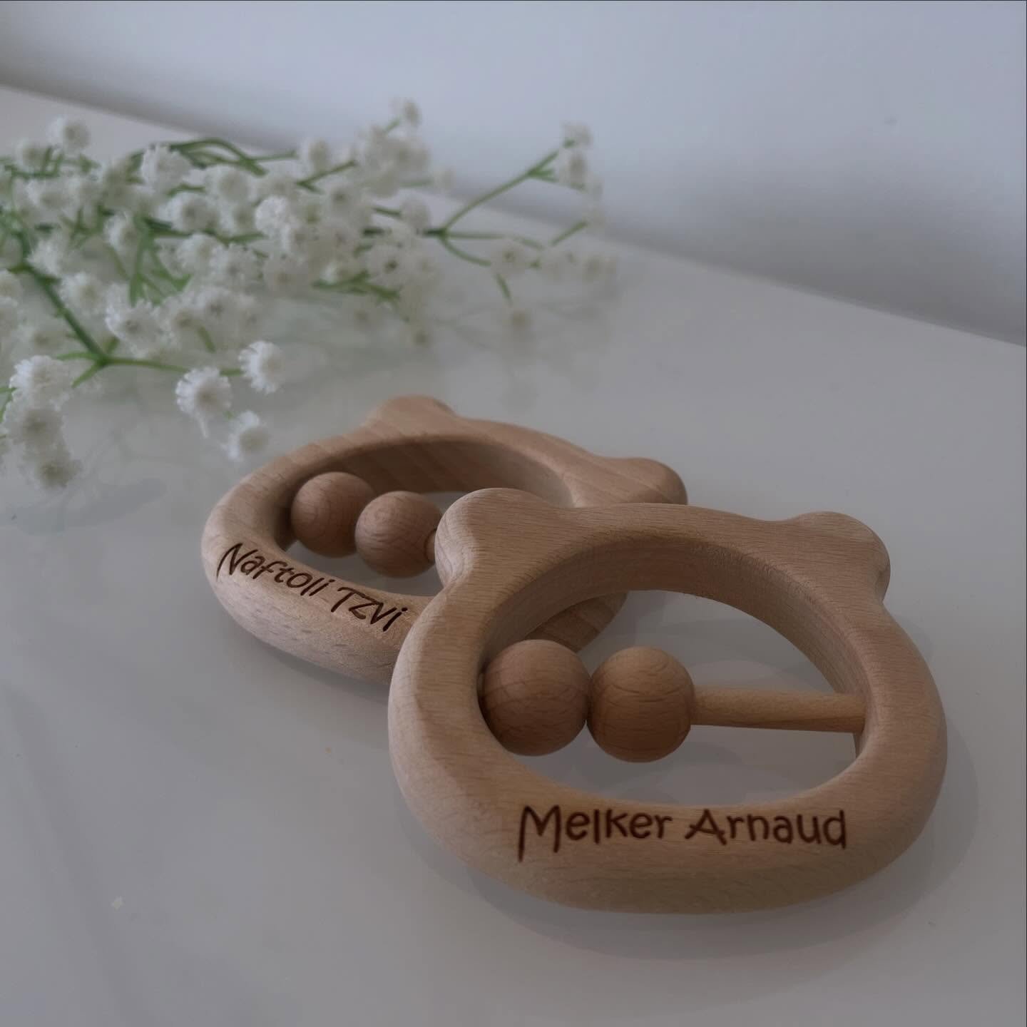 A timeless piece for brand new arrivals.

This engraved wooden rattle, crafted in the shape of a little bear, was created as a personalised keepsake to celebrate a precious new baby. Made from natural wood and engraved with care, it is designed to be