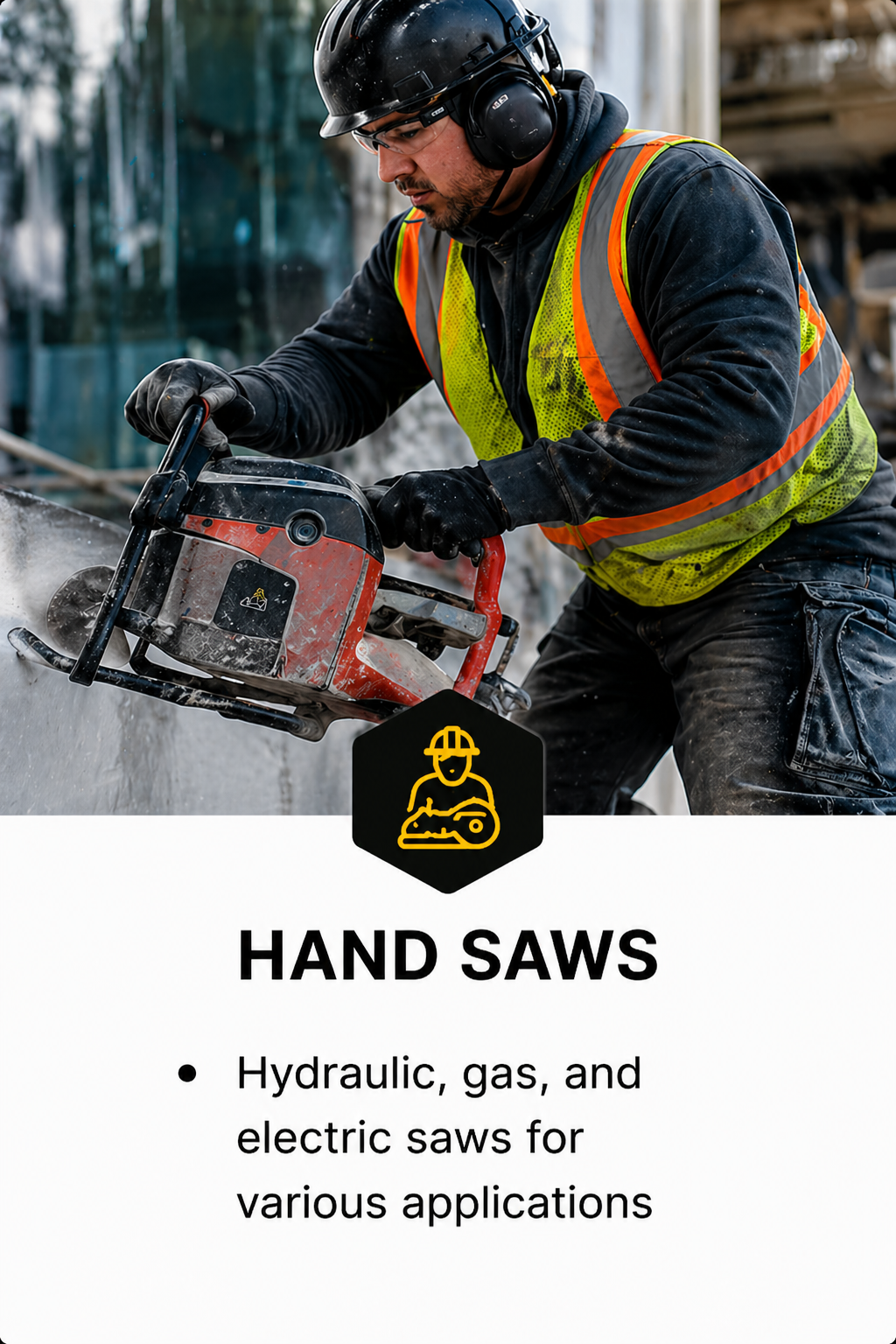 A construction worker using a hand saw at a construction site, wearing a black helmet, safety ear protection, a high visibility safety vest, and gloves.