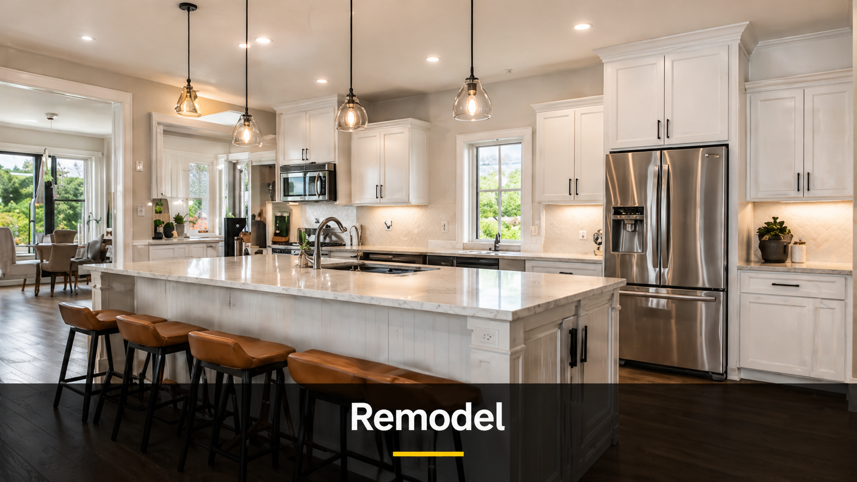Modern kitchen with white cabinets, stainless steel appliances, marble island with leather stools, pendant lighting, and windows with greenery view.