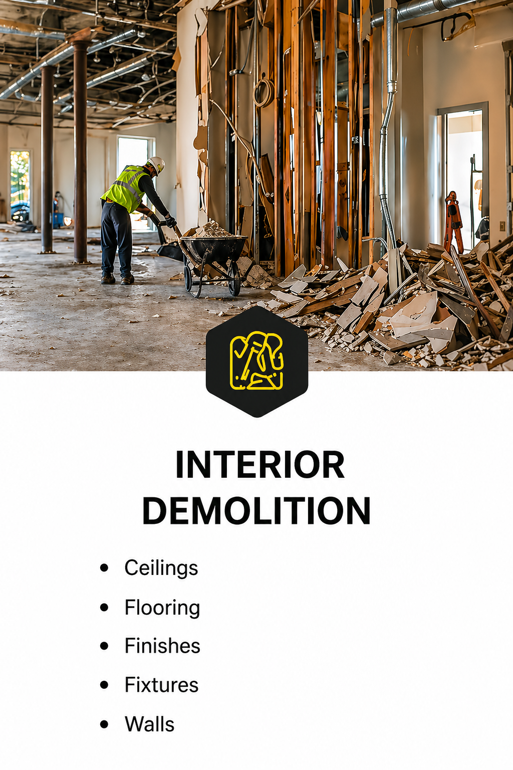 Construction worker in a high-visibility vest and helmet demolishing interior walls with debris and exposed framing around.