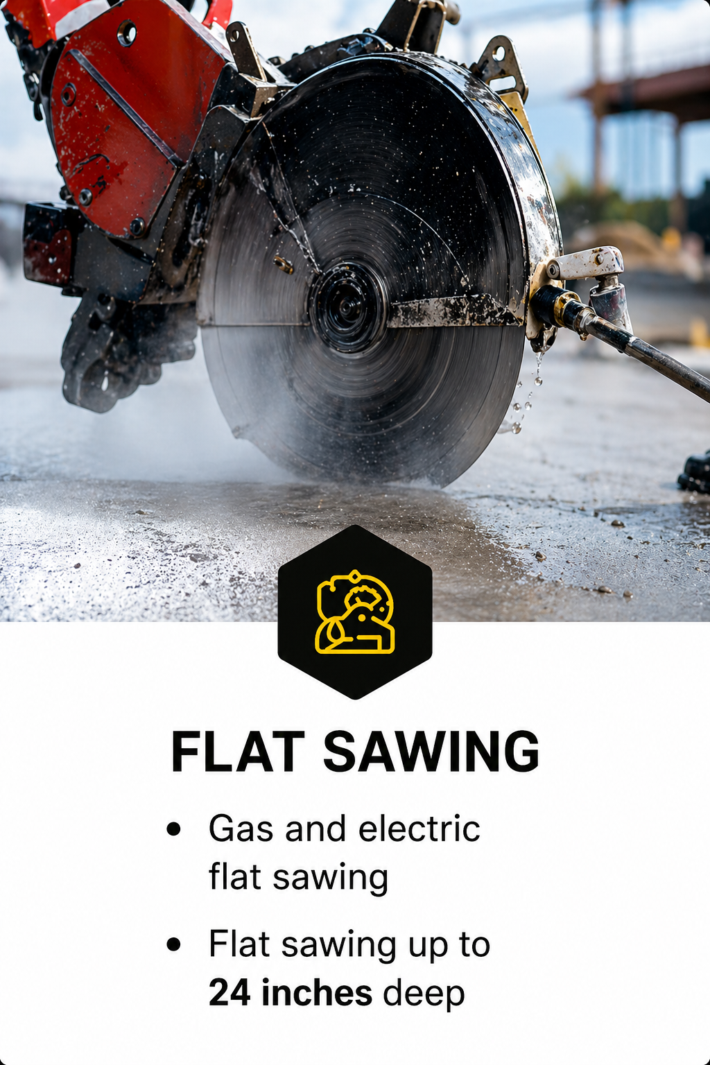 A close-up of a large circular saw blade cutting through concrete, with water spray cooling the blade, at a construction site.