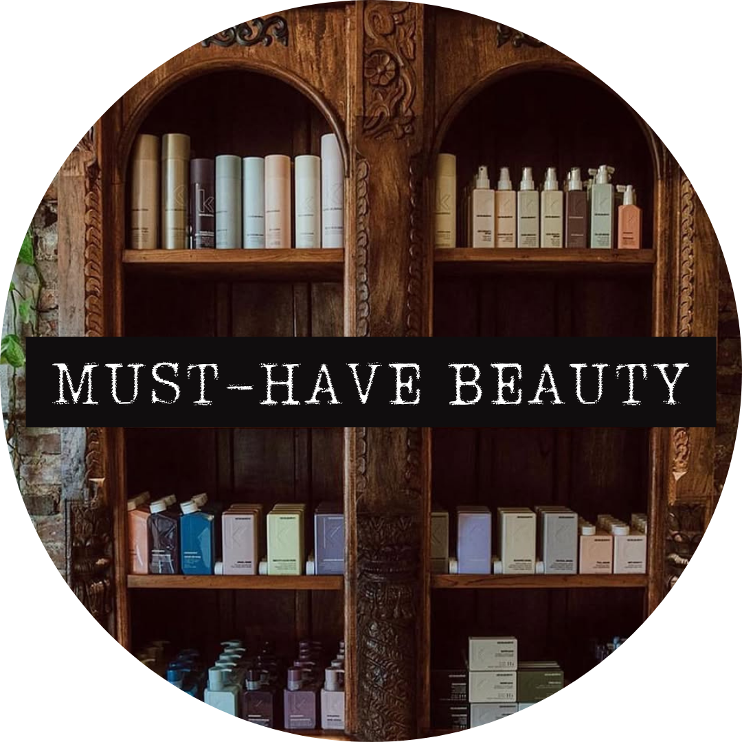Wooden shelves filled with various bottles and boxes of beauty or skincare products, with the overlay text 'MUST-HAVE BEAUTY'.