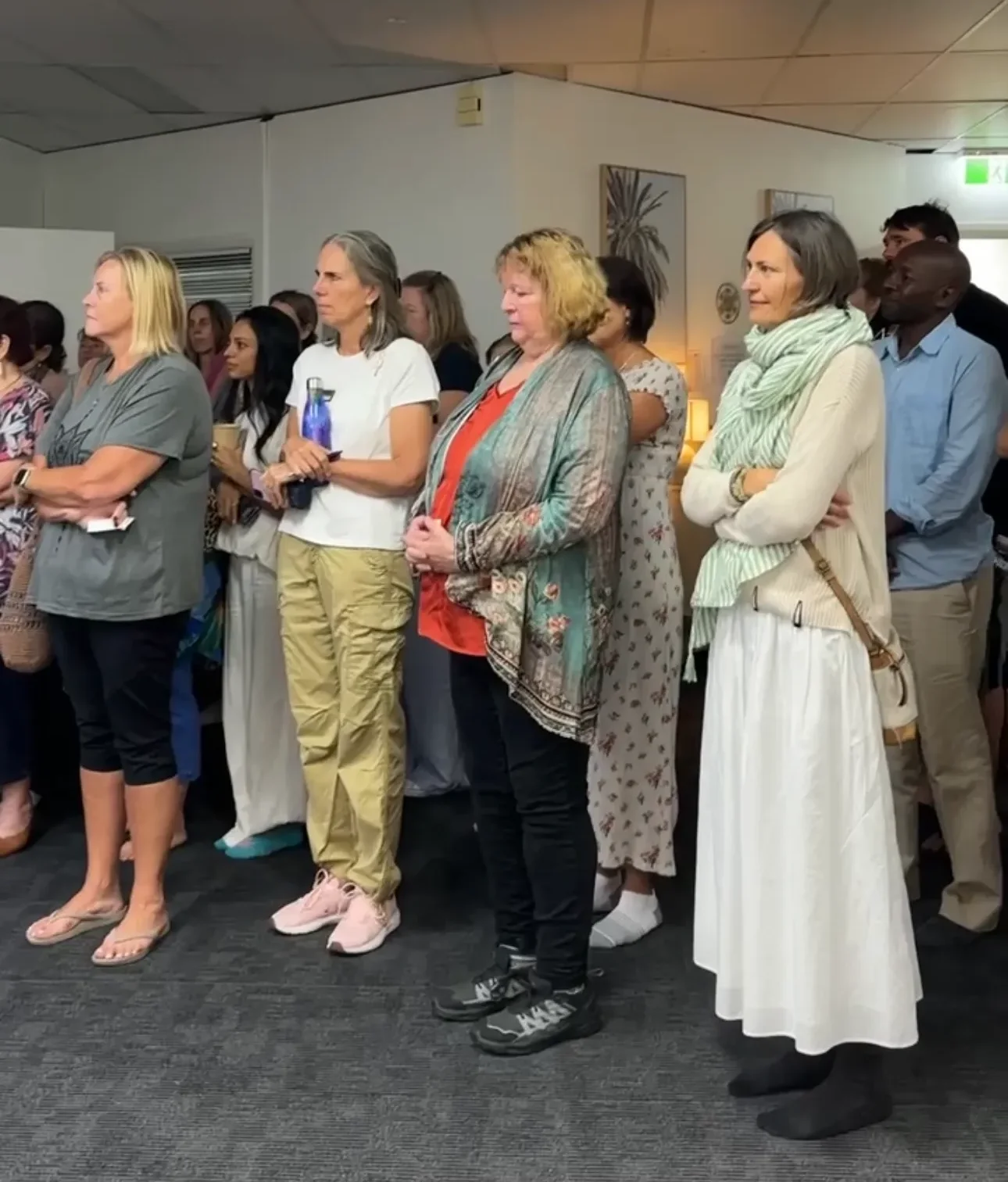 Large crowd of Soulibrium community members standing together at a wellness event