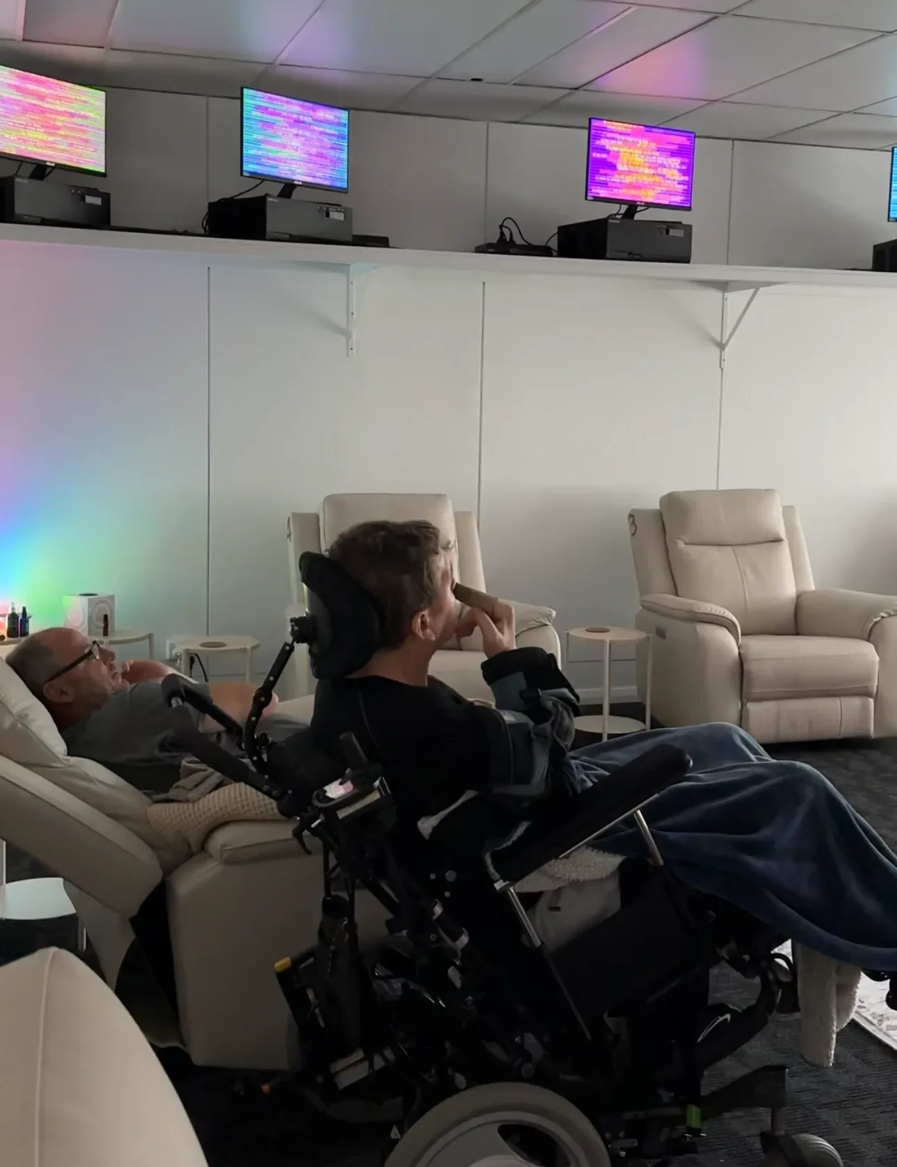 Two clients including a wheelchair user relaxing together during a Soulibrium sensory wellness session