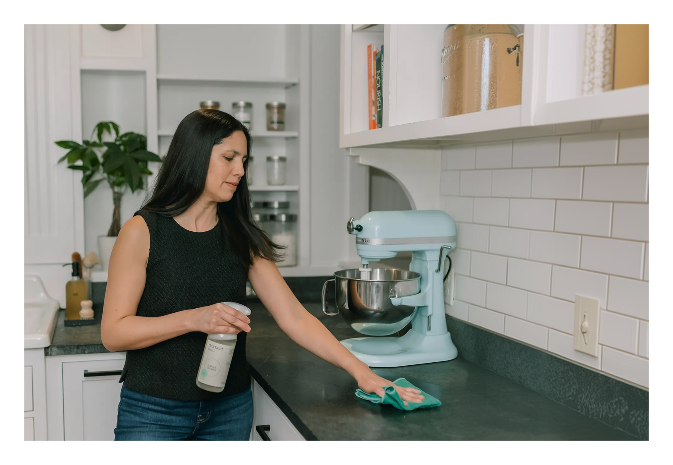 Claudia Zimmerman wiping a soapstone countertop with Everneat surface cleaner