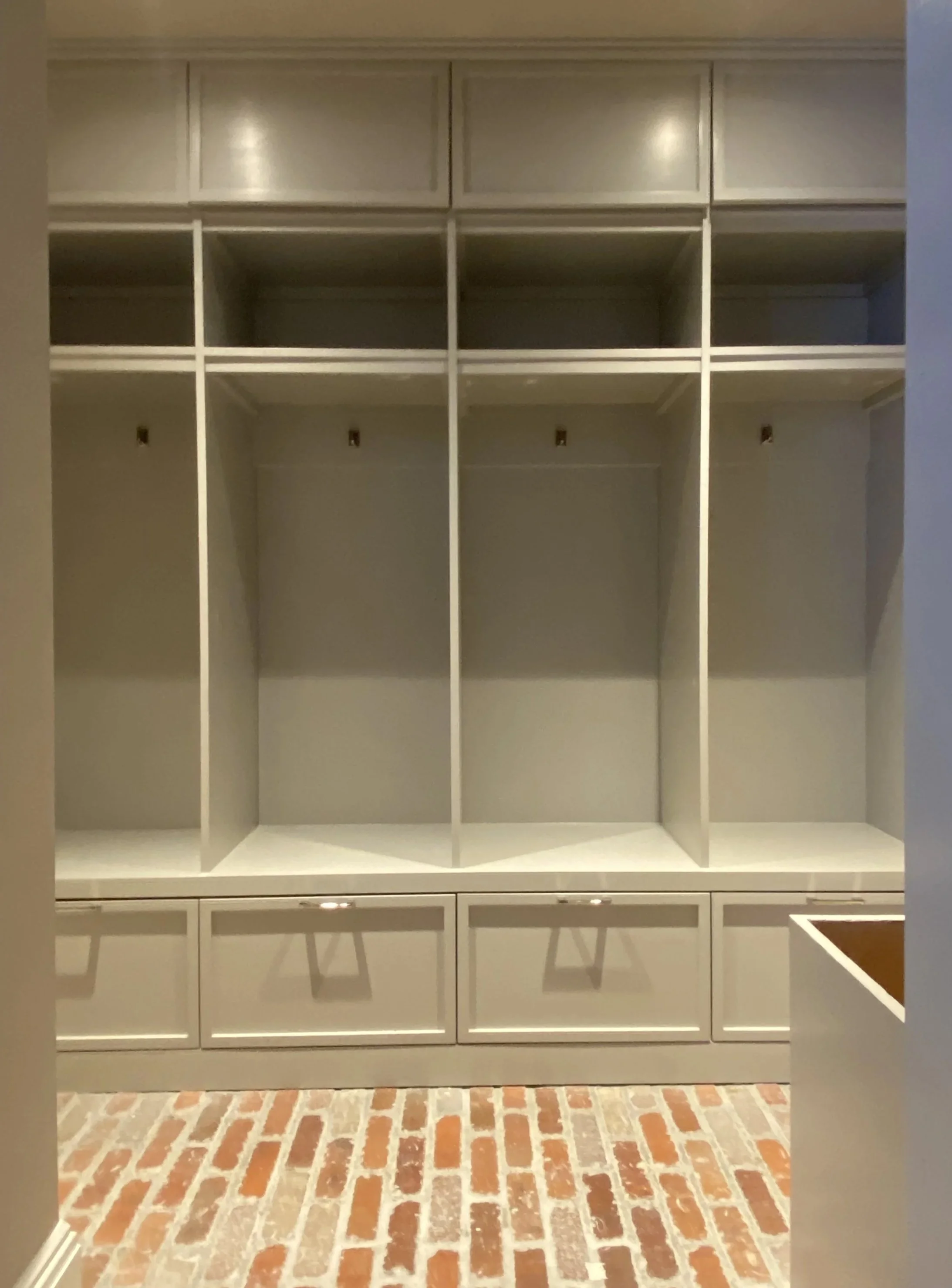 Darien mudroom after renovation by Ginger Lemon Indigo, custom built-in storage painted in Farrow and Ball gray with RH hardware and recessed lighting