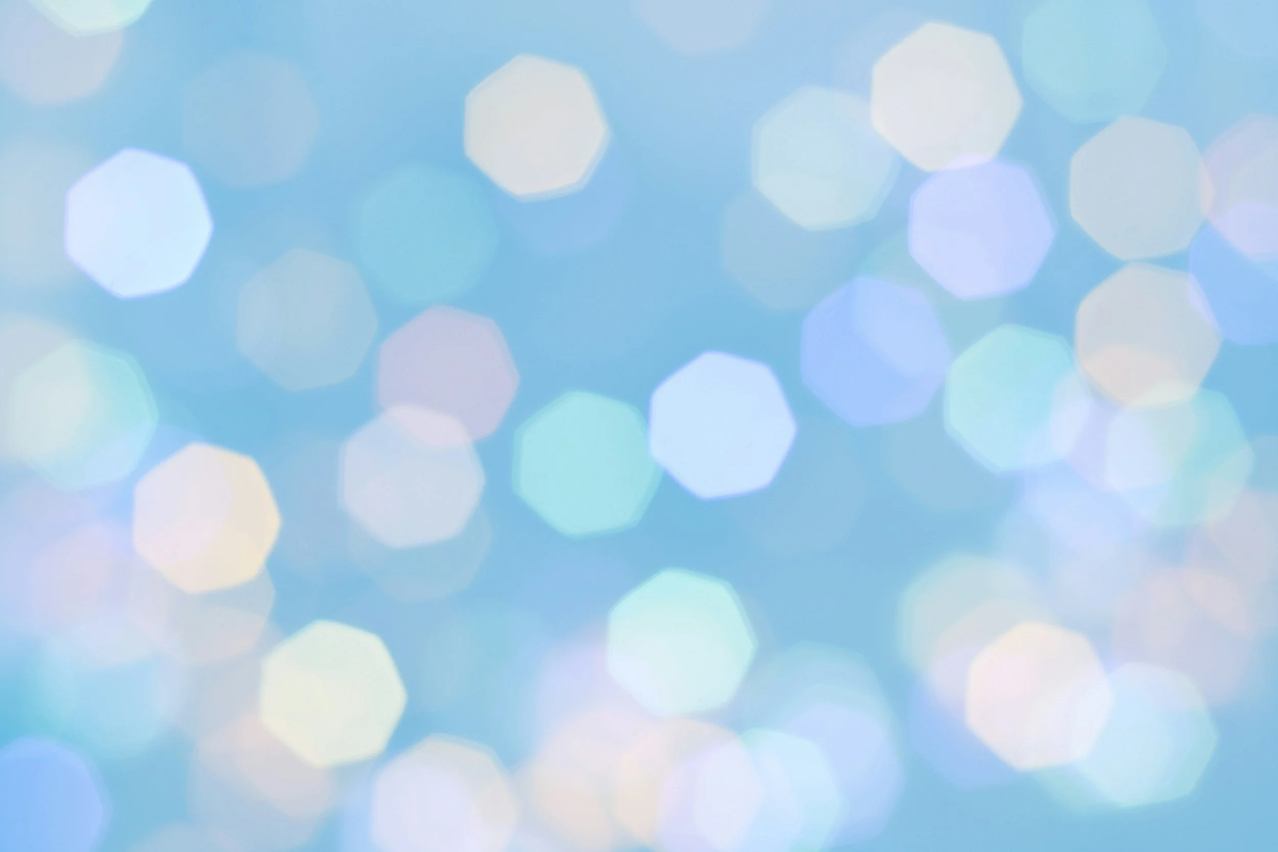 Abstract blue bokeh background with out-of-focus light spots.