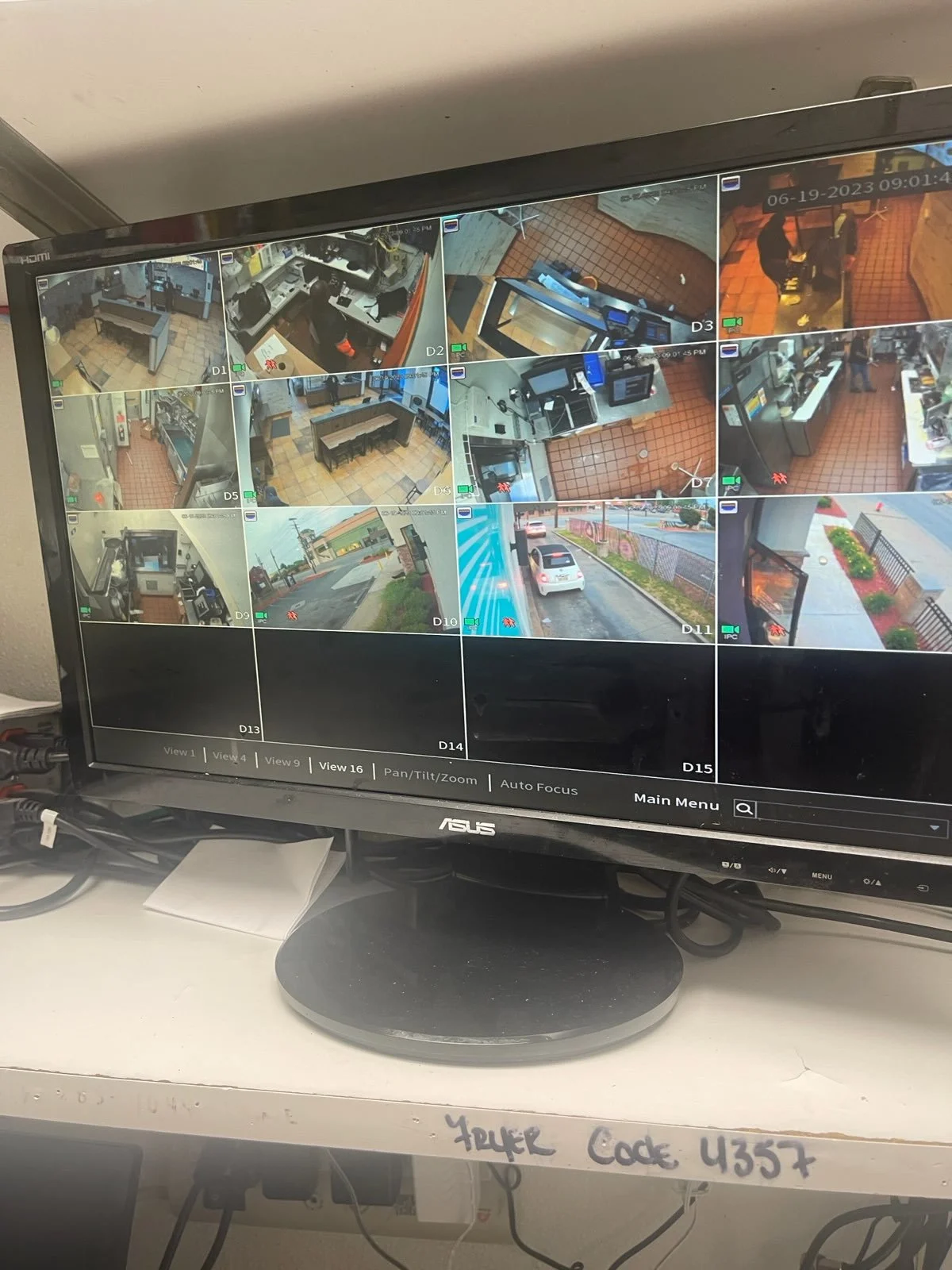 Surveillance monitor displaying multiple security camera feeds of an indoor and outdoor area, with some feeds showing building interiors and others showing street views.