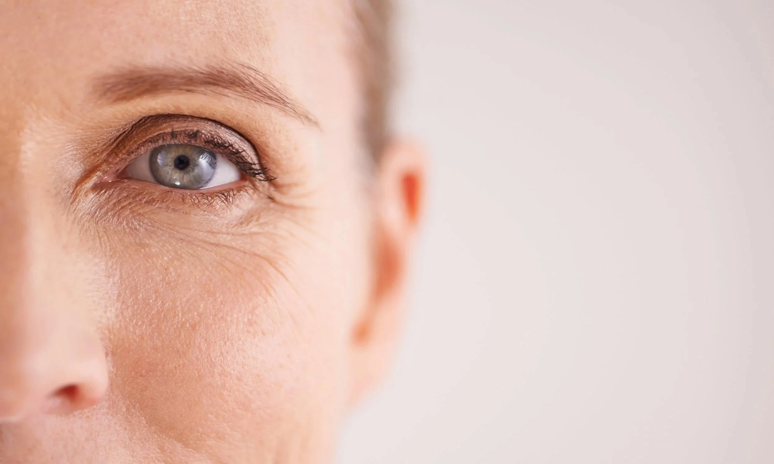 Close-up of a woman's eye looking directly out from the frame.