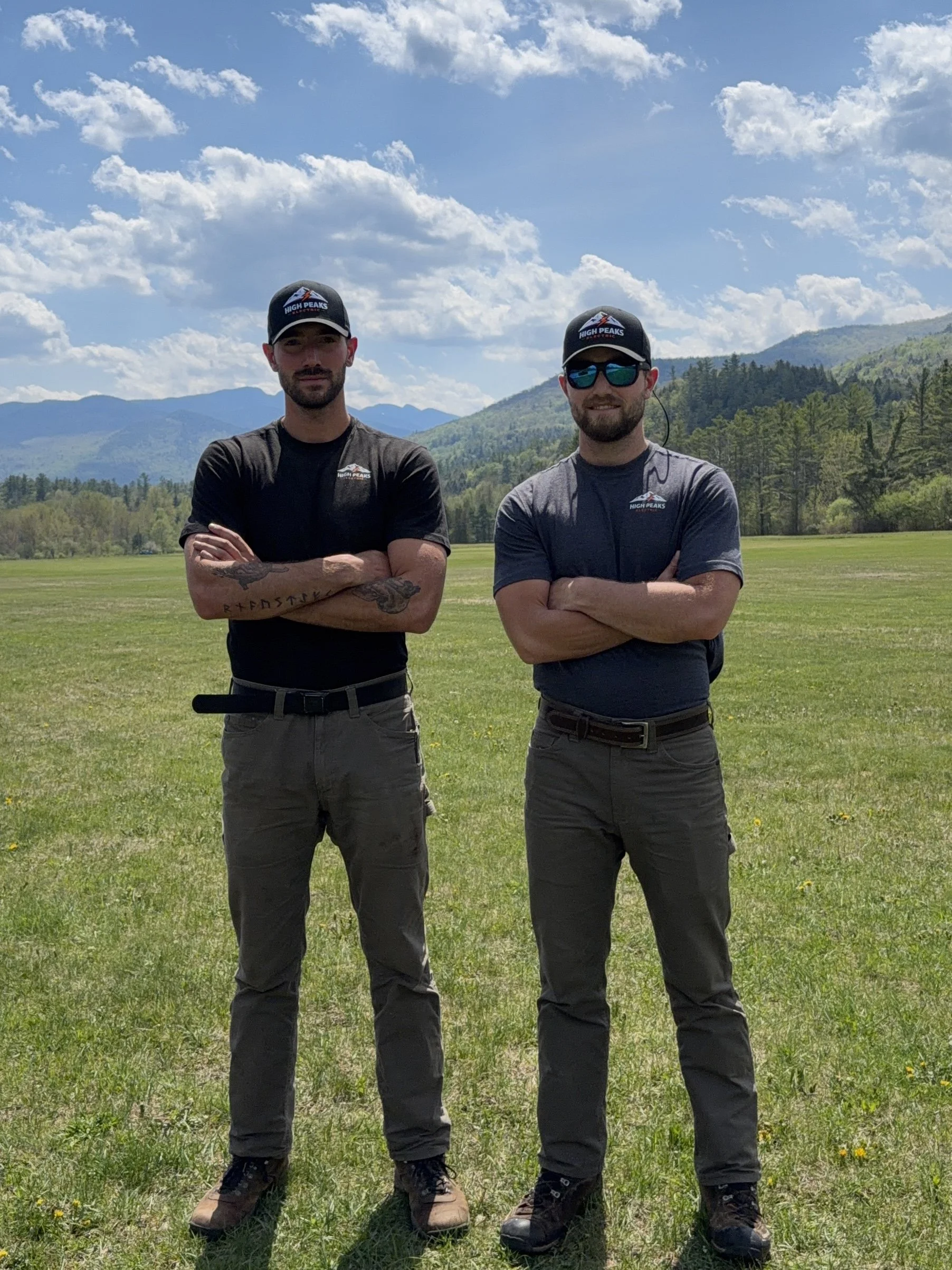 Carson Blades and Colden Blades brothers and Founders of High Peaks Electric standing together in front of Mountains in Keene, NY.