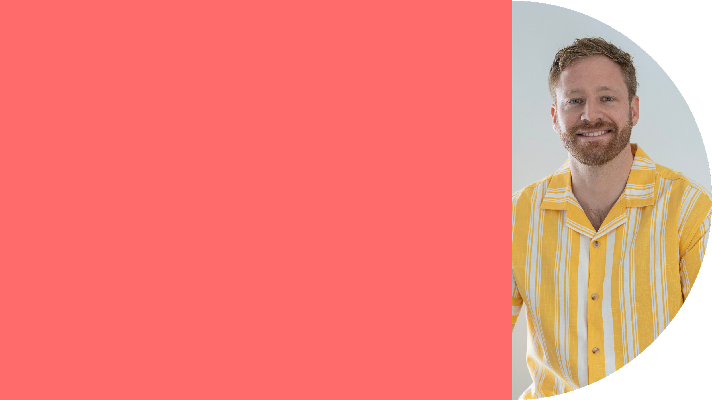 A young man with red hair and a beard wearing a yellow and white striped shirt smiling at the camera.