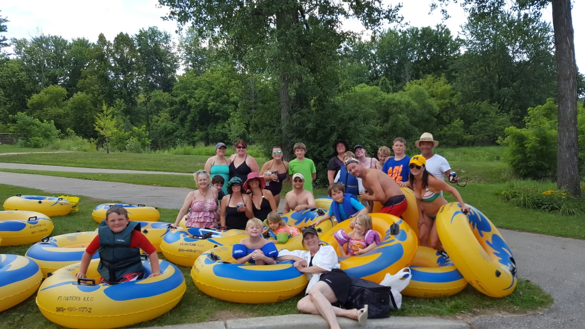 Large group relaxing on tubes during a summer river float in Mt. Pleasant, MI.