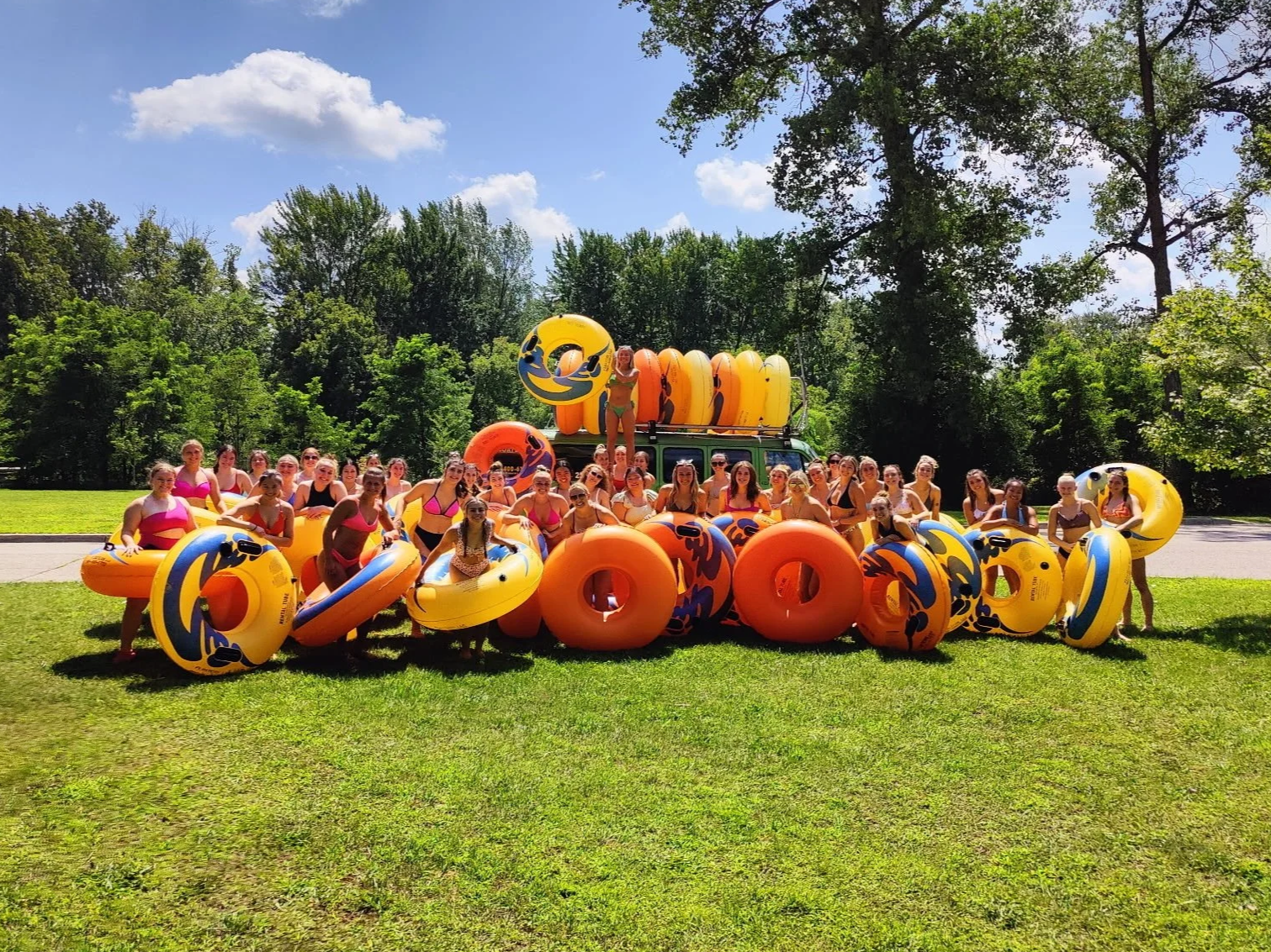 Friends enjoying river tube rentals on a calm Michigan river.