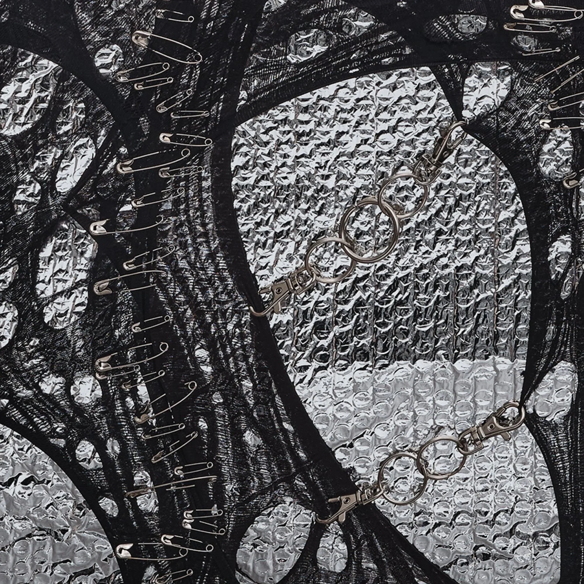 Macro view showing utilitarian metal bindings secured through synthetic mesh.