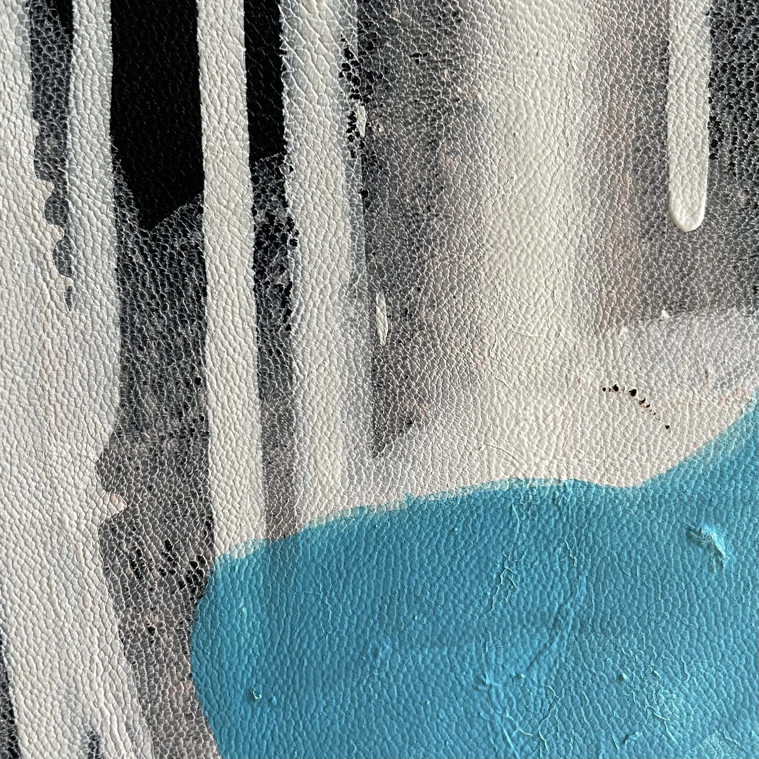 Close-up of a textured surface with black, white, and light blue colors, possibly part of a painted or printed material.