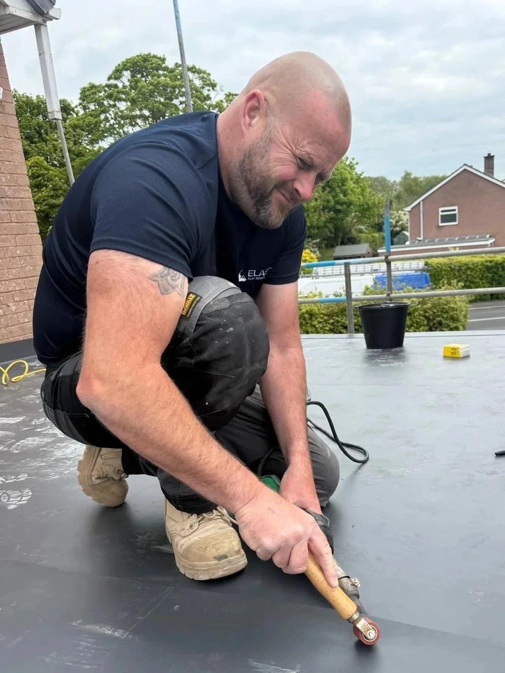 Jamie Hodgson, founder of ELAST Flat Roofing Solutions, installing a premium flat roof membrane on a property in Carlisle.