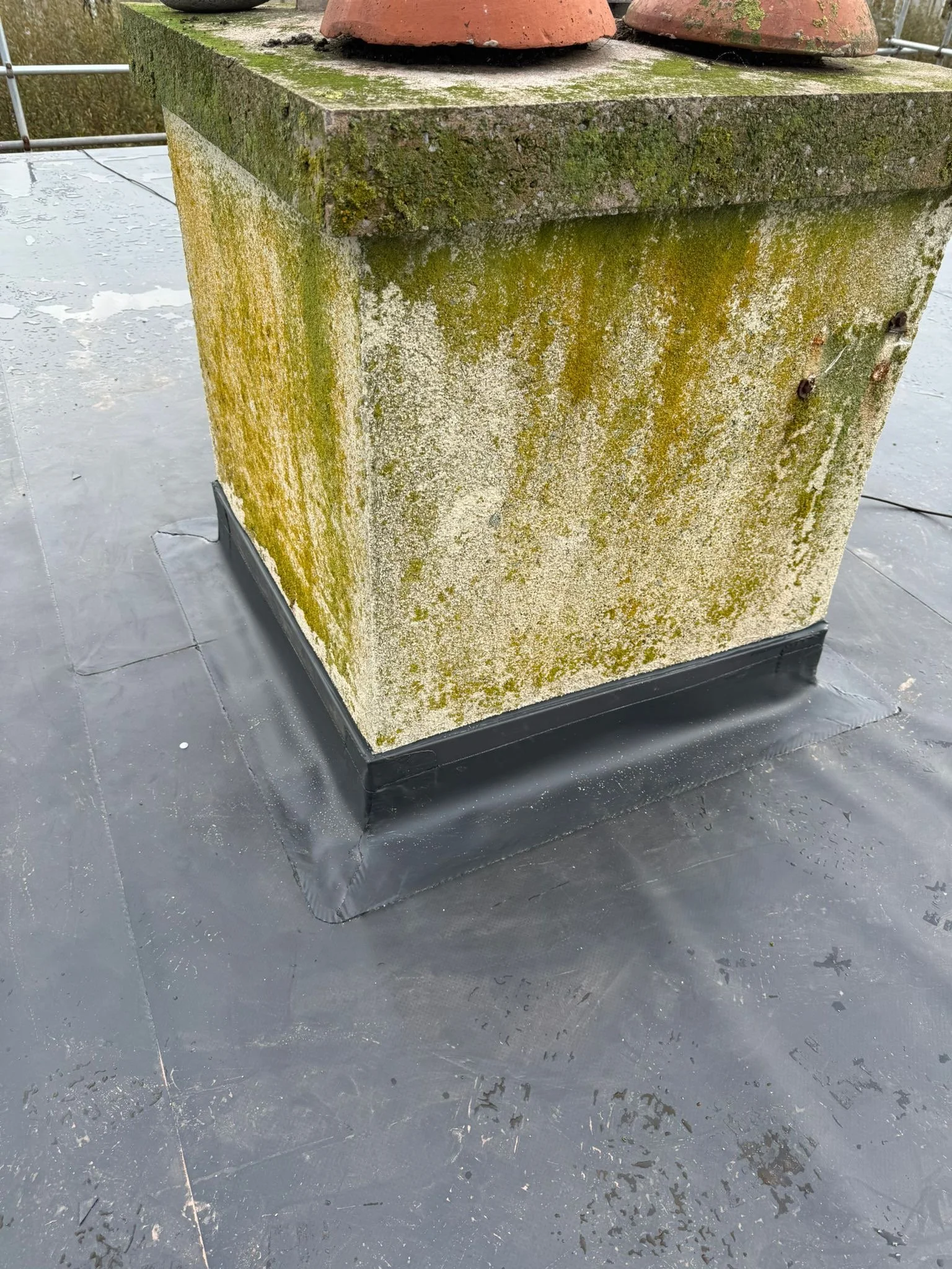 Roof restoration in cumbria, showcasing expert seam around chimney