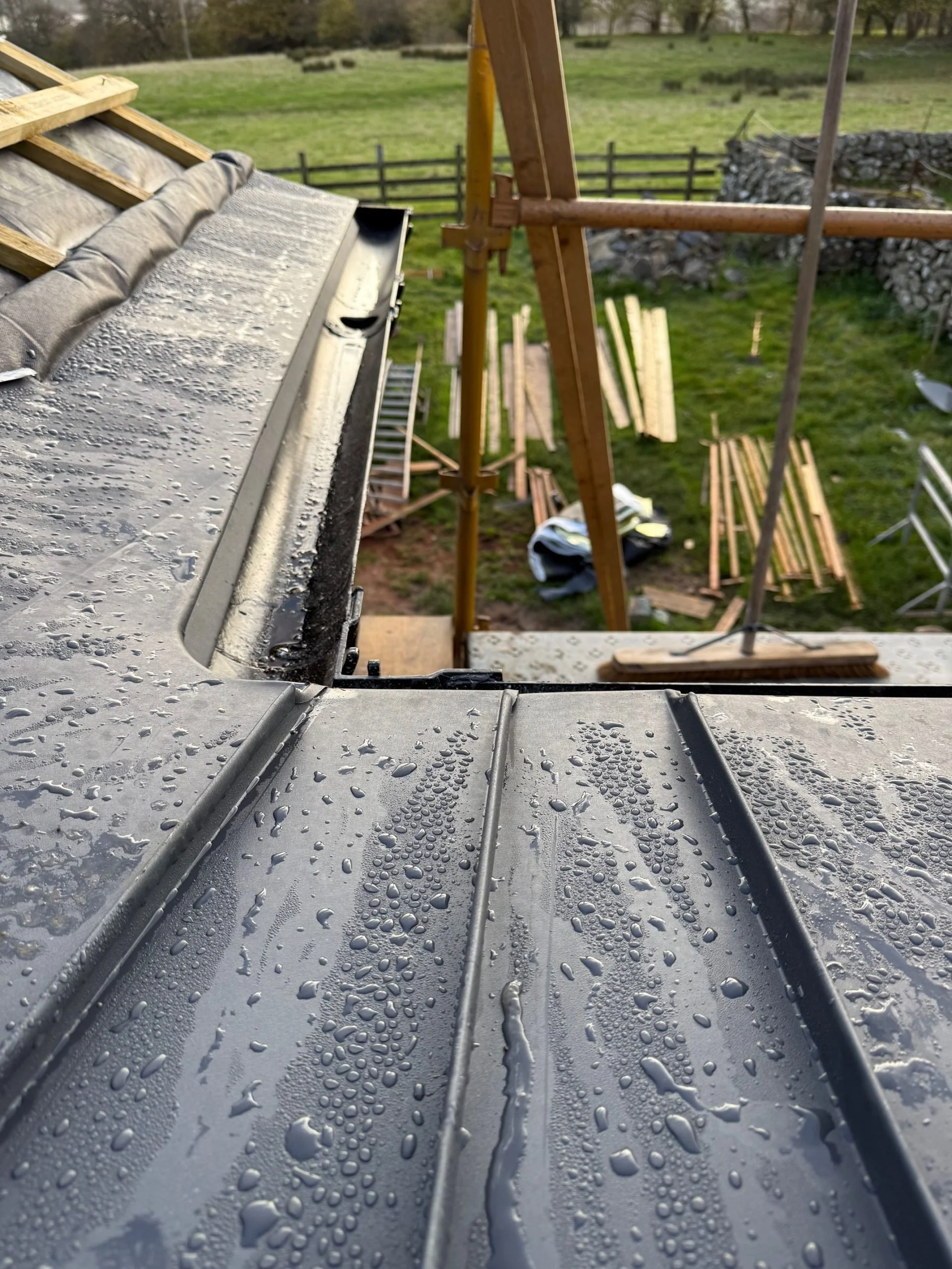 High-precision metal roofing valley and gutter intersection layout, showcasing water-tight engineering built to withstand heavy weather.