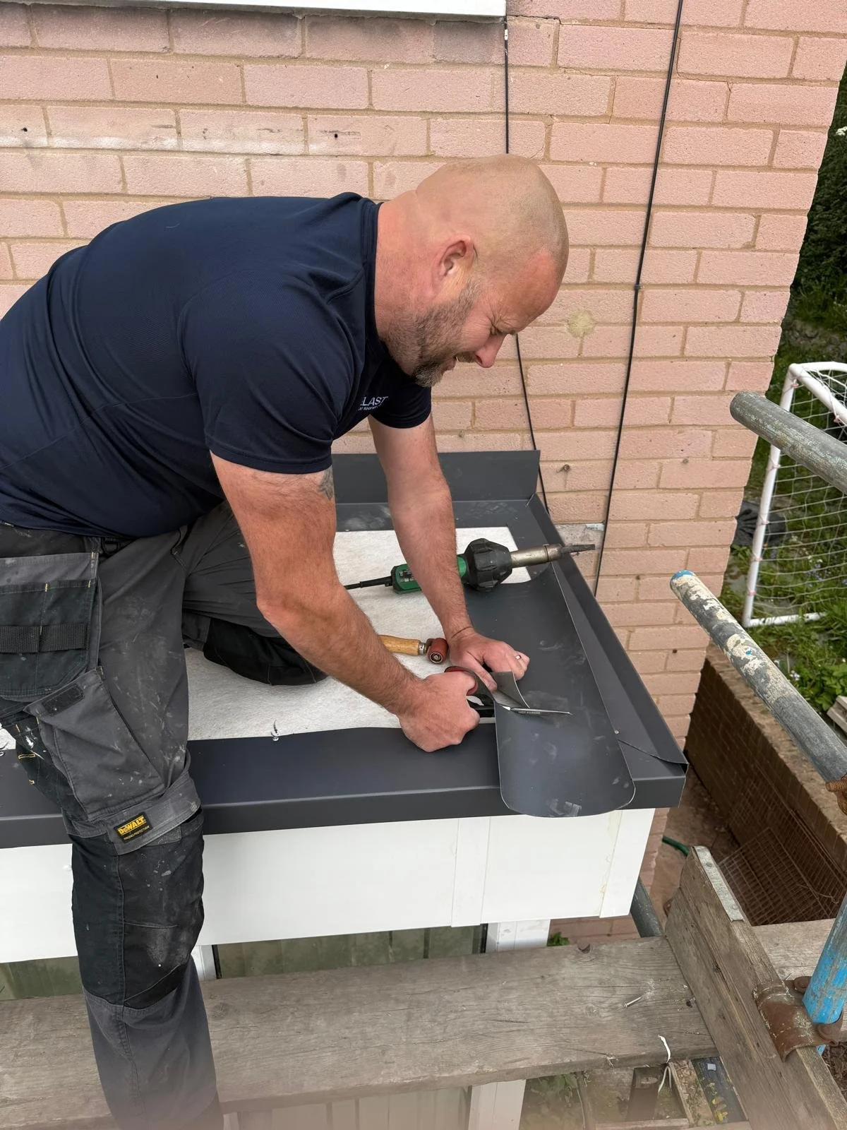 Jamie Hodgson, local Carlisle native with 20 years experience, working on a Cumbrian flat roof project.