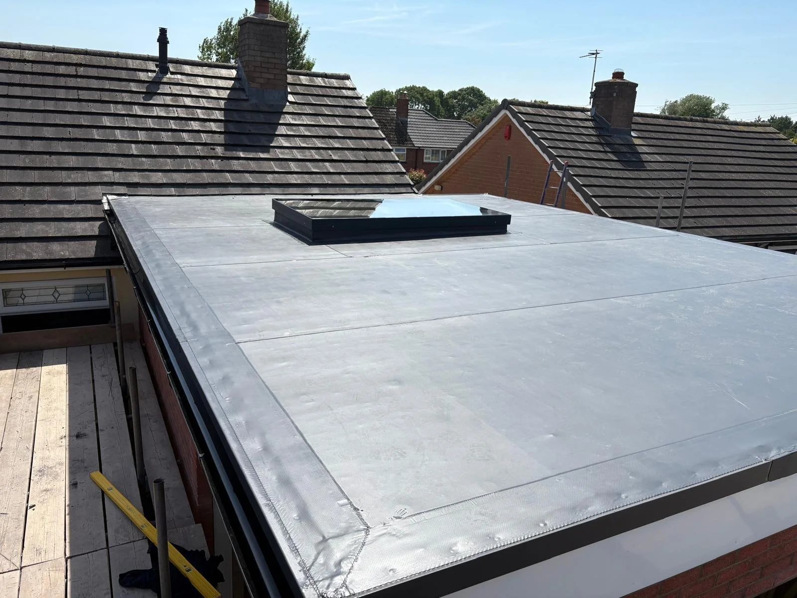 A new roof on an extension building in Carlisle Cumbria, including a perfect seal around the edges and modern skylight window for the lasting waterproof warranty. 
