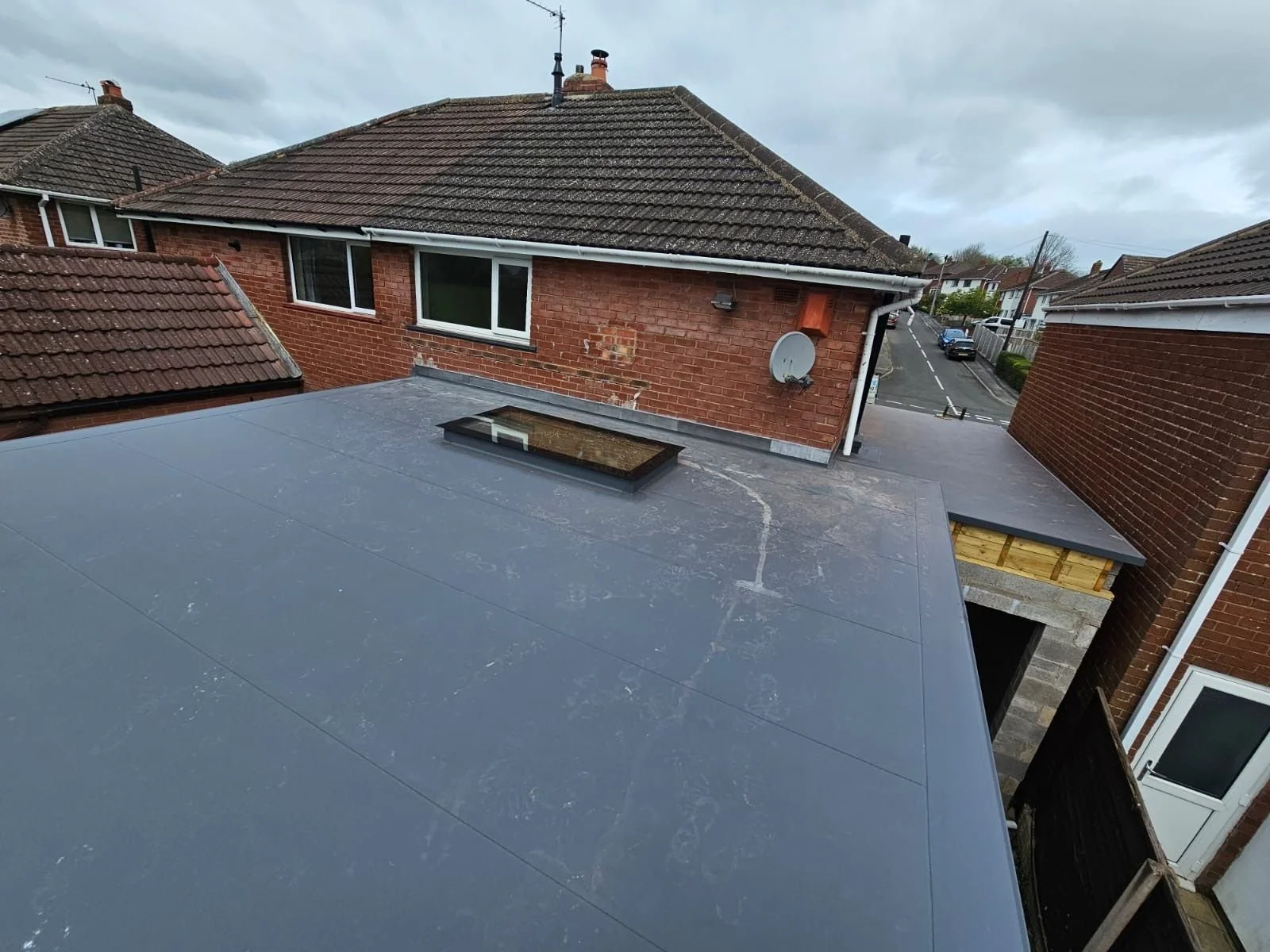Side profile of a standing seam roof showing intricate gutter integration and drainage.