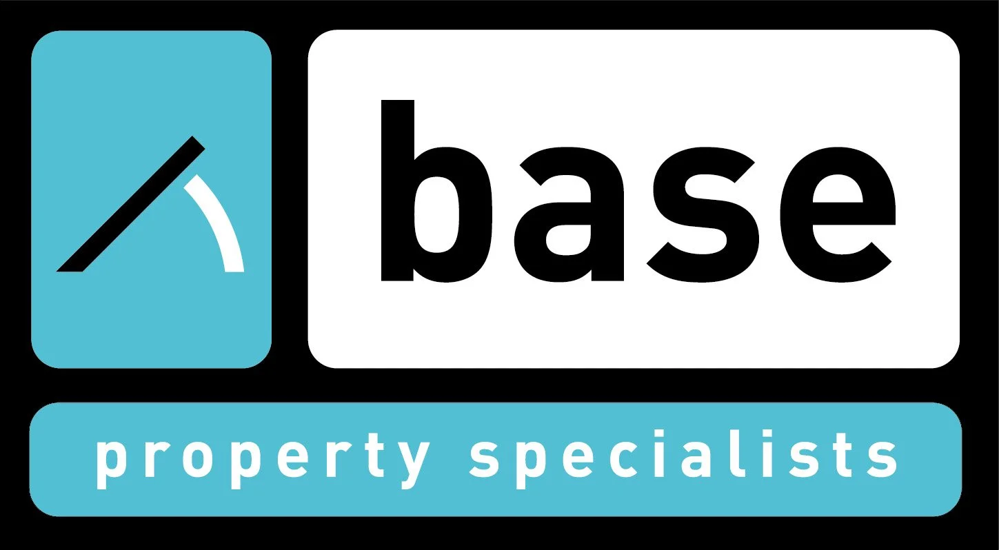 Logo for Base Property Specialists, featuring a blue square with a black and white gauge icon, and the words "base" in black and "property specialists" in white on a blue background.